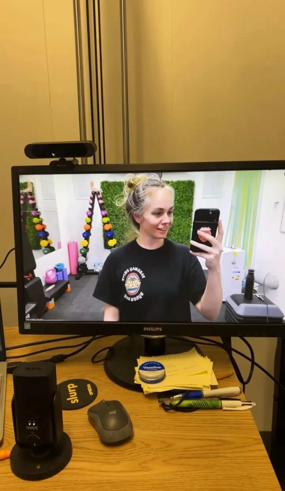 Amy Snelling teaching a live online fitness class, seen on a laptop screen.