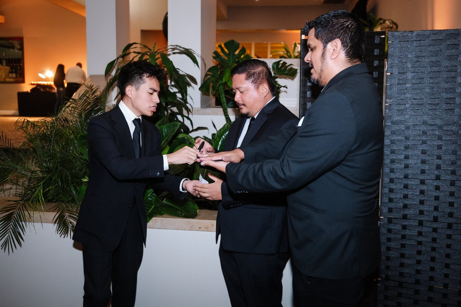 Jacob Martinez performing close-up magic in a guest's hands