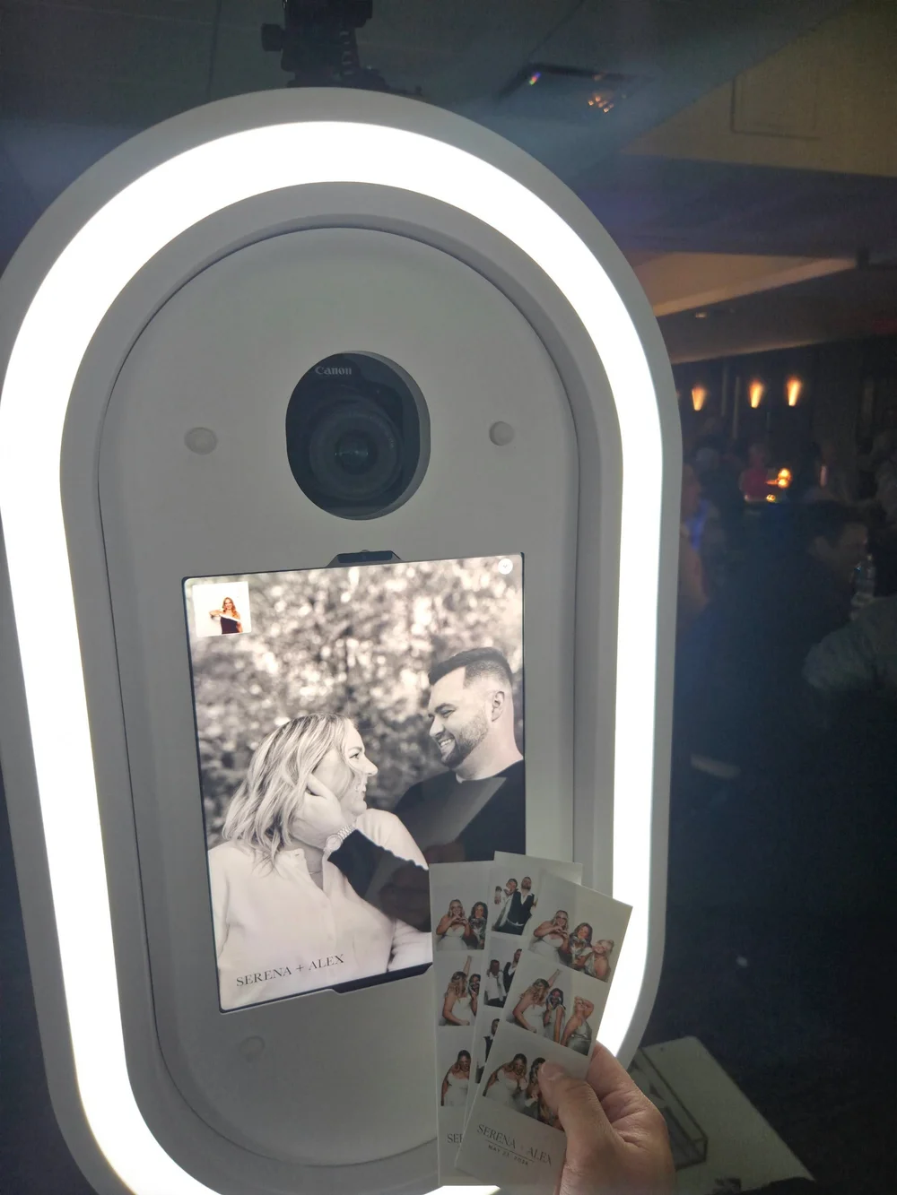 Nova photo booth with custom printed wedding photo strips at a Winnipeg reception