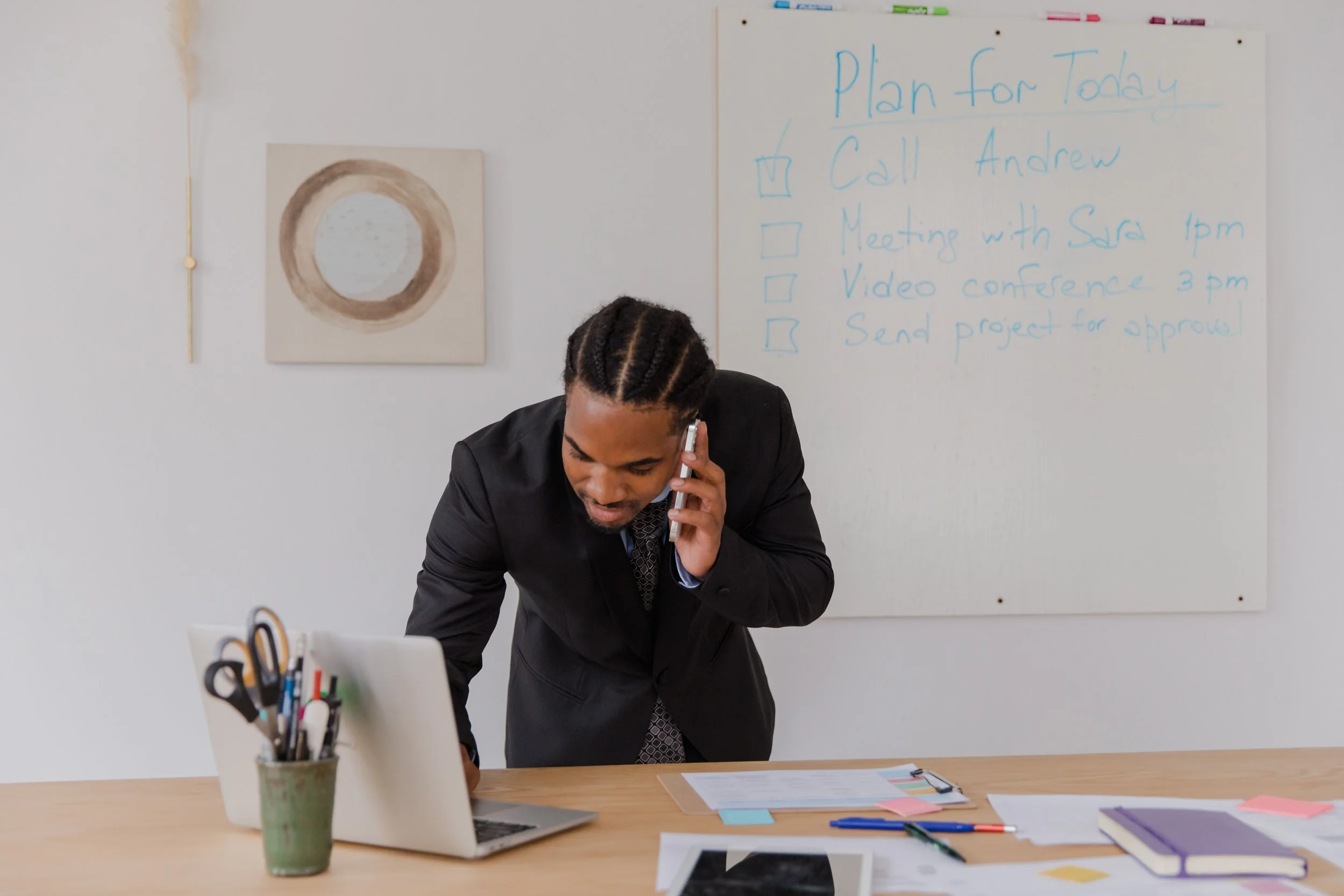 Business owner reviewing a website on a laptop to identify why ad traffic is not turning into calls.