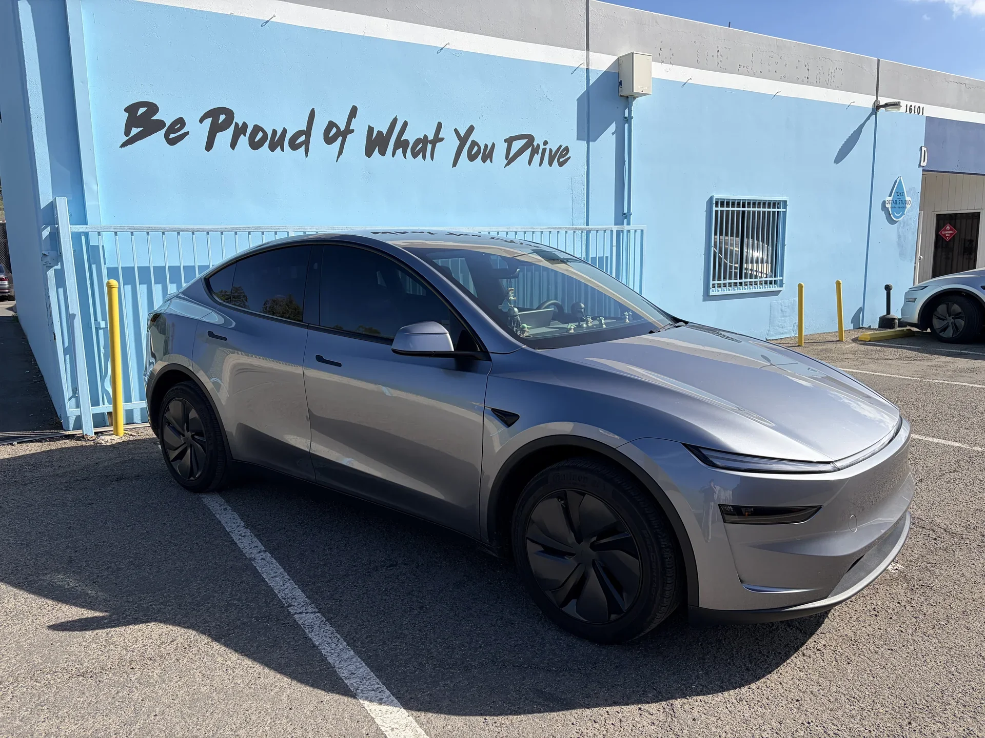 2026 Tesla Model Y — front three-quarter view parked outside the studio