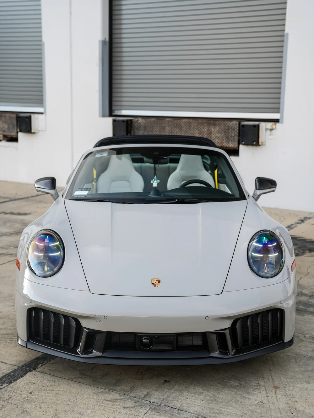 Porsche 911 Targa GTS viewed directly from the front with both headlights and mirrors visible