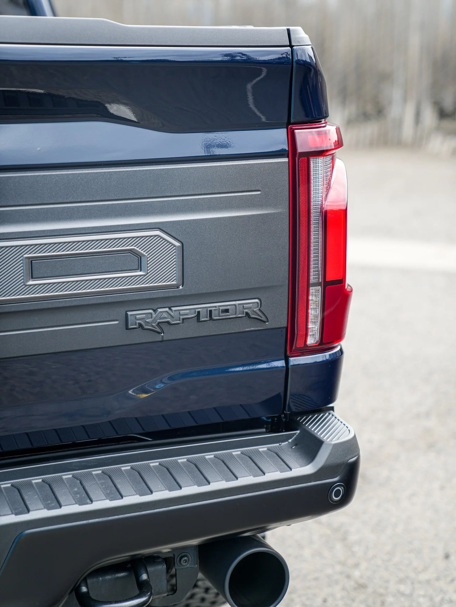 Dark Blue Ford F-150 Raptor after Paint Protection Film (PPF) and Window Tint, rear body and taillight view