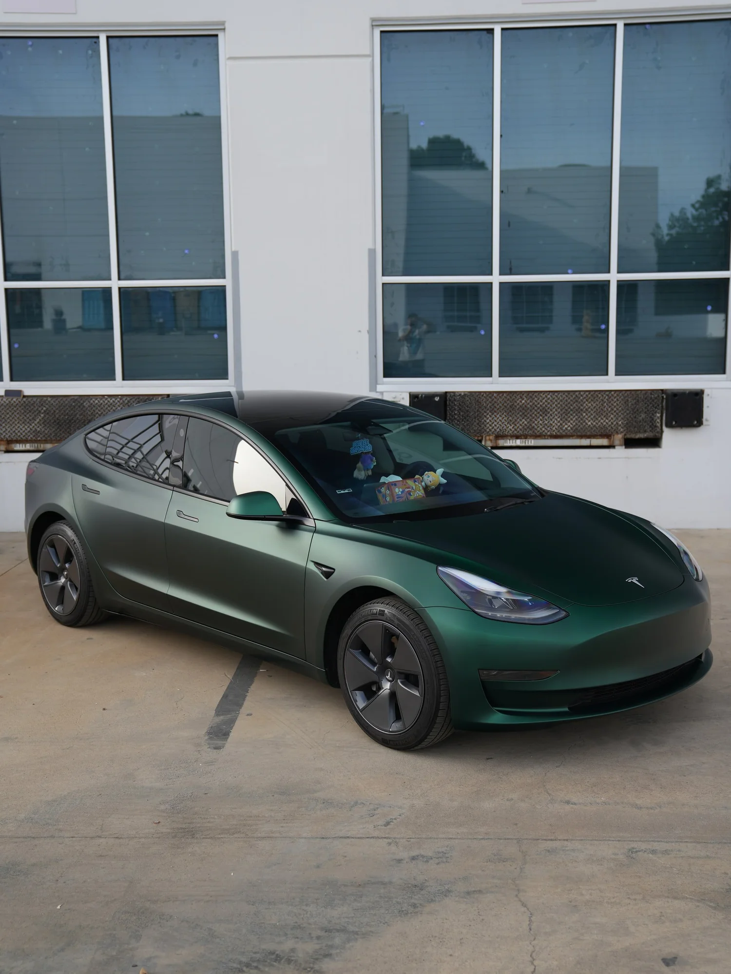 Tesla Model 3 Ghost Matte Green after Vinyl Wrap, front-left three-quarter view