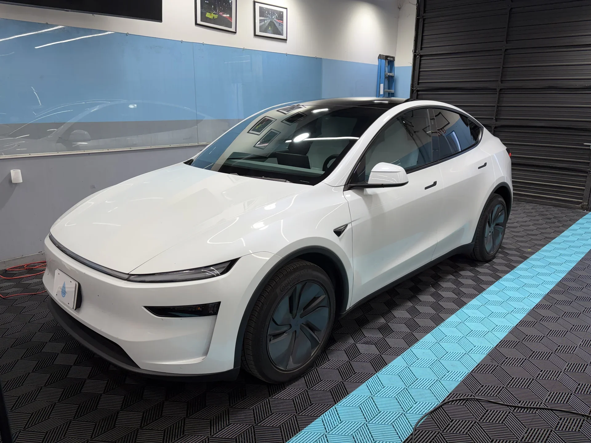 2026 Tesla Model Y Premium — front three-quarter view inside the studio