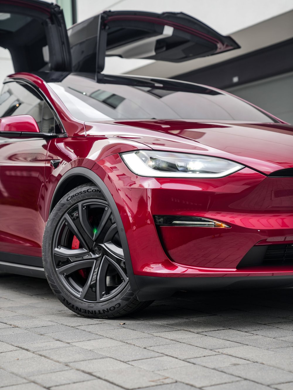 Tesla Model X PPF and XR Plus tint project, closer front-corner view with falcon-wing doors raised