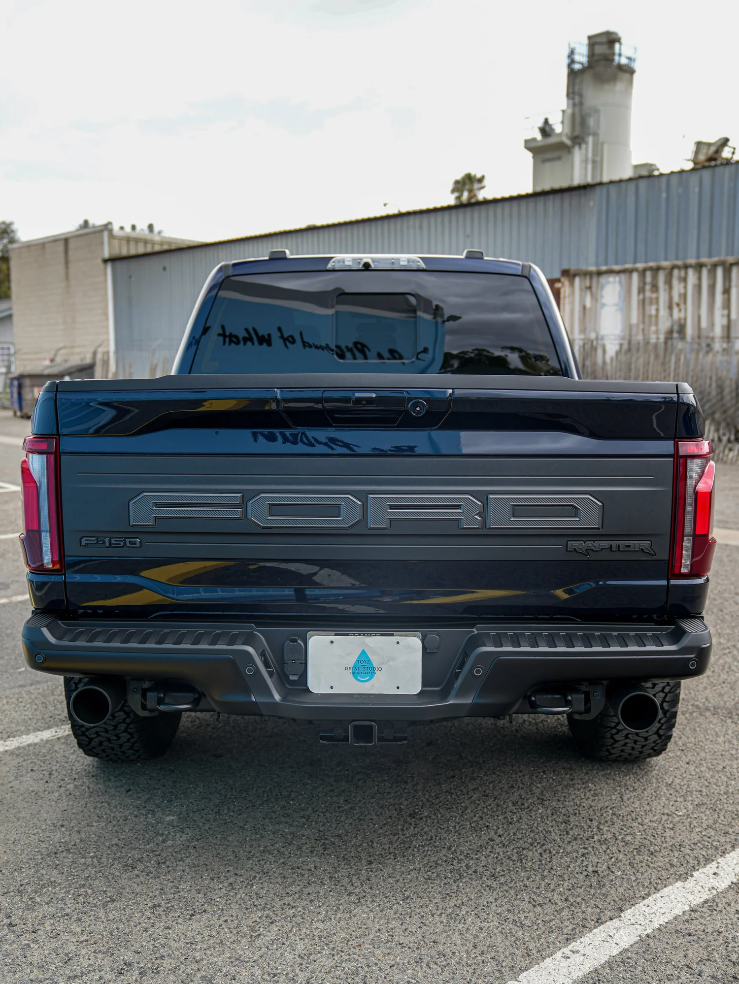 Dark Blue Ford F-150 Raptor after Paint Protection Film (PPF) and Window Tint, rear-right three-quarter view