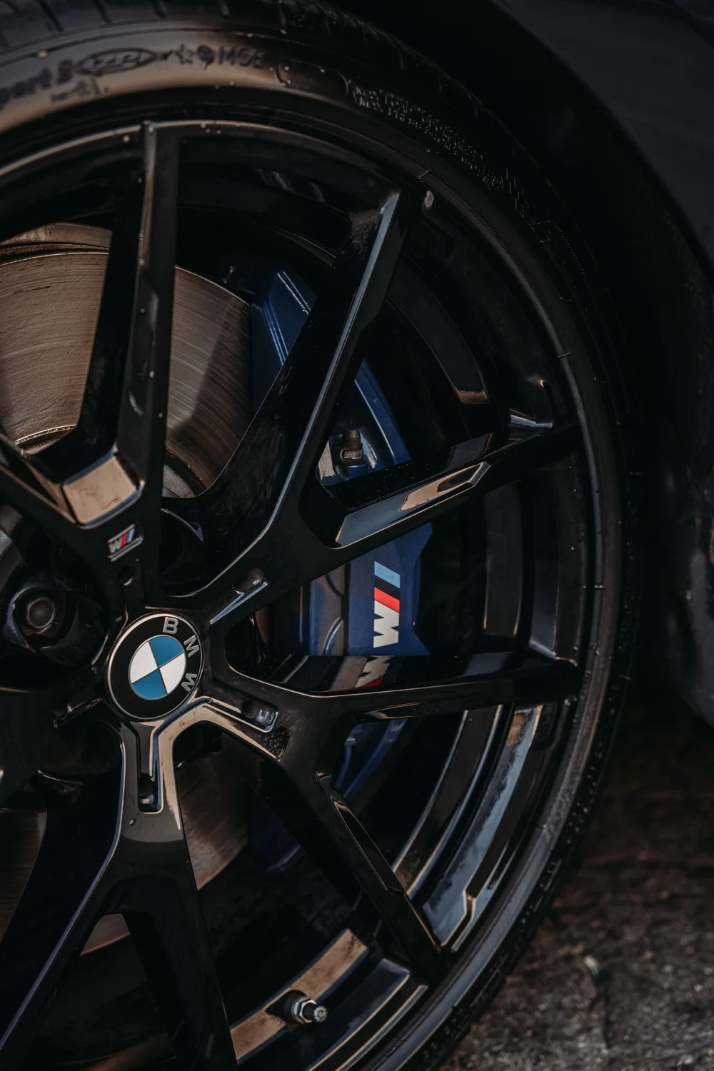 Installed BMW M850i wheel close-up with the brake caliper visible through the spokes