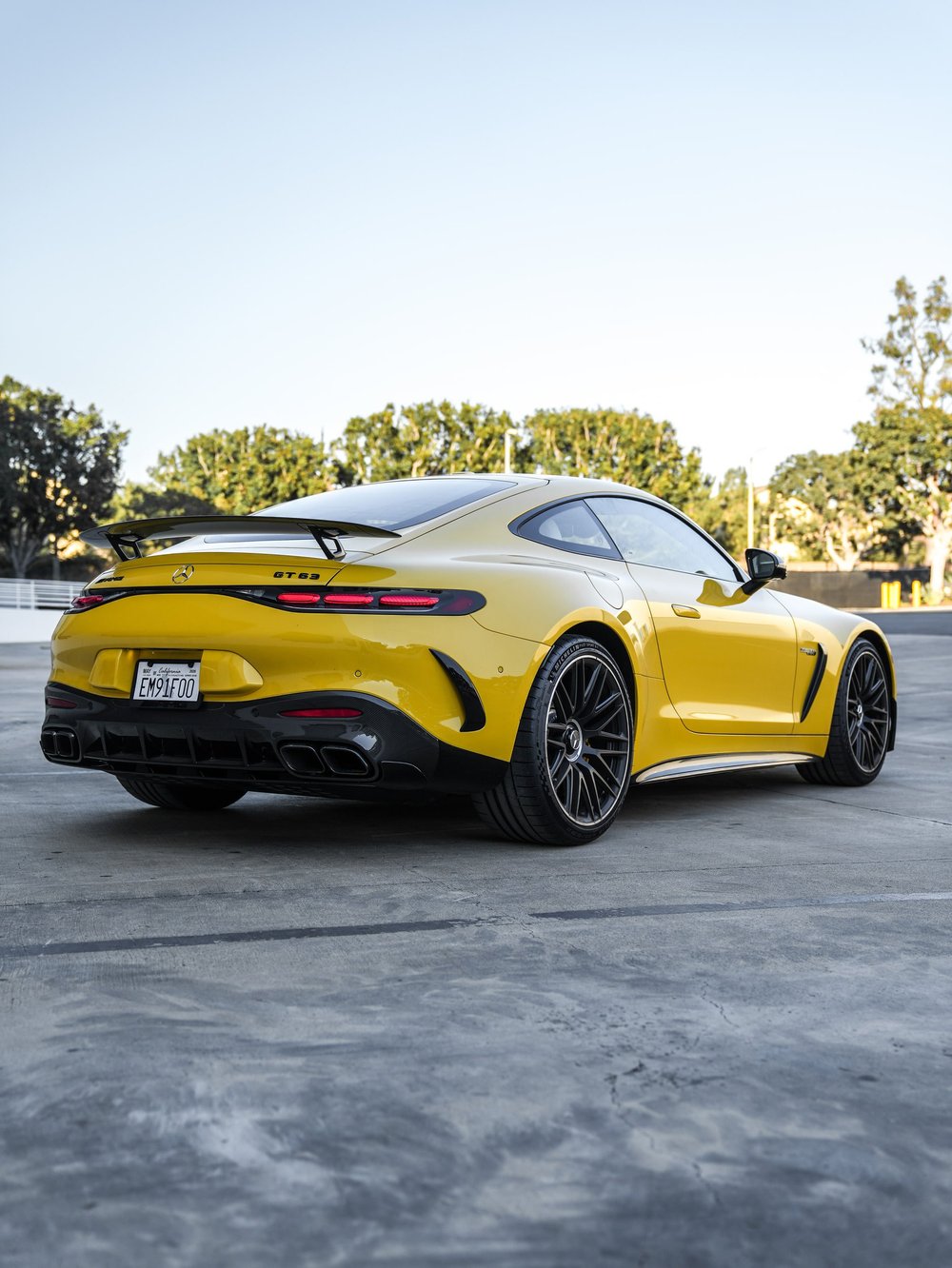 Yellow Mercedes-AMG GT 63, rear three-quarter view with raised spoiler