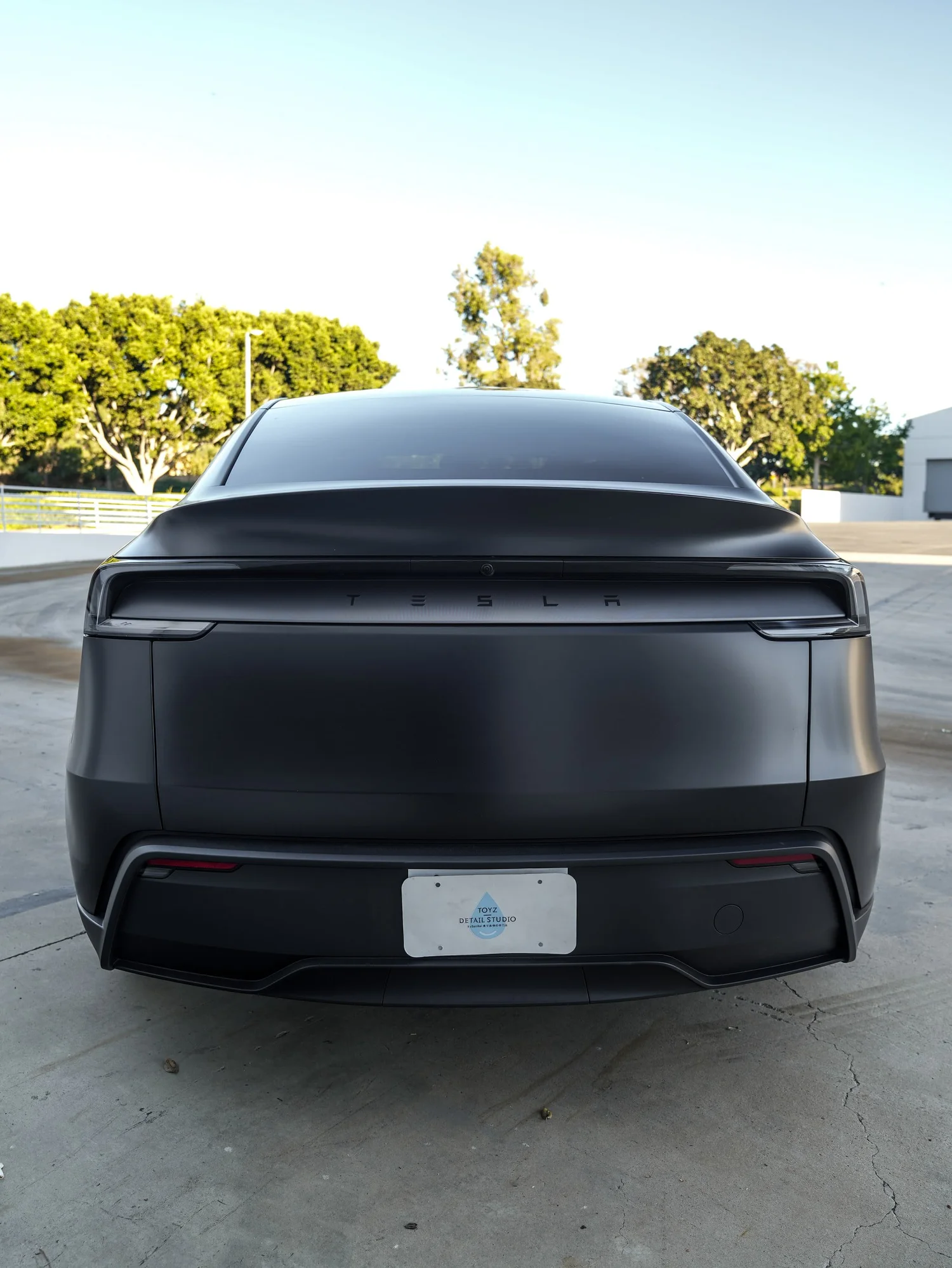 Tesla Model Y 3M Satin Black after Vinyl Wrap, low-angle rear view