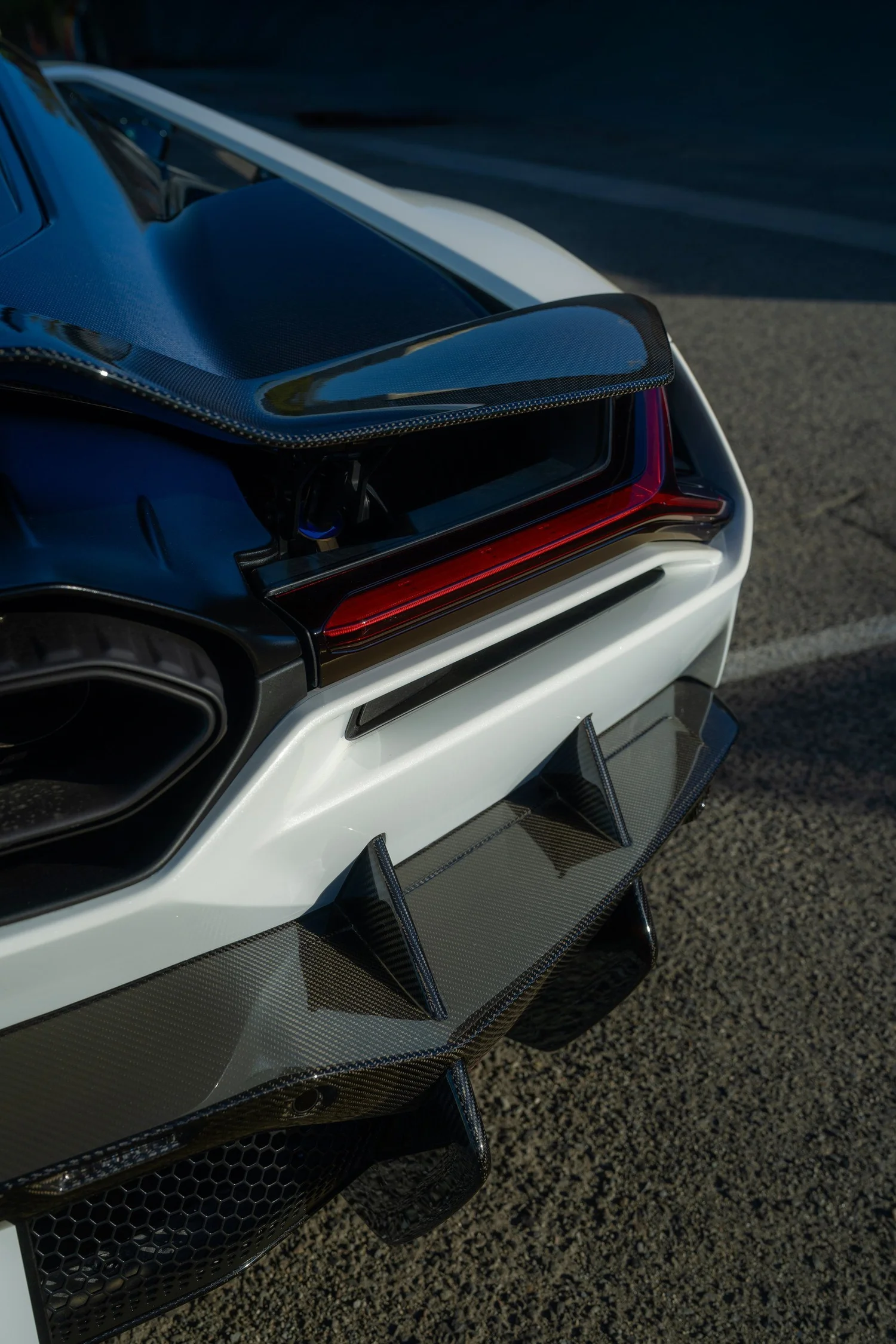 Close view of the Revuelto tail lamp, glossy carbon trim and rear diffuser.