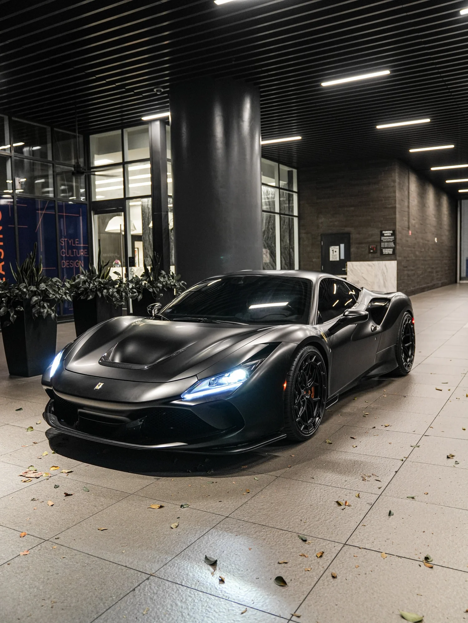 Ferrari F8 3M Satin Black after Vinyl Wrap, wide indoor studio view