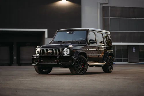 Dark Mercedes-AMG G 63 with black wheels, front three-quarter view