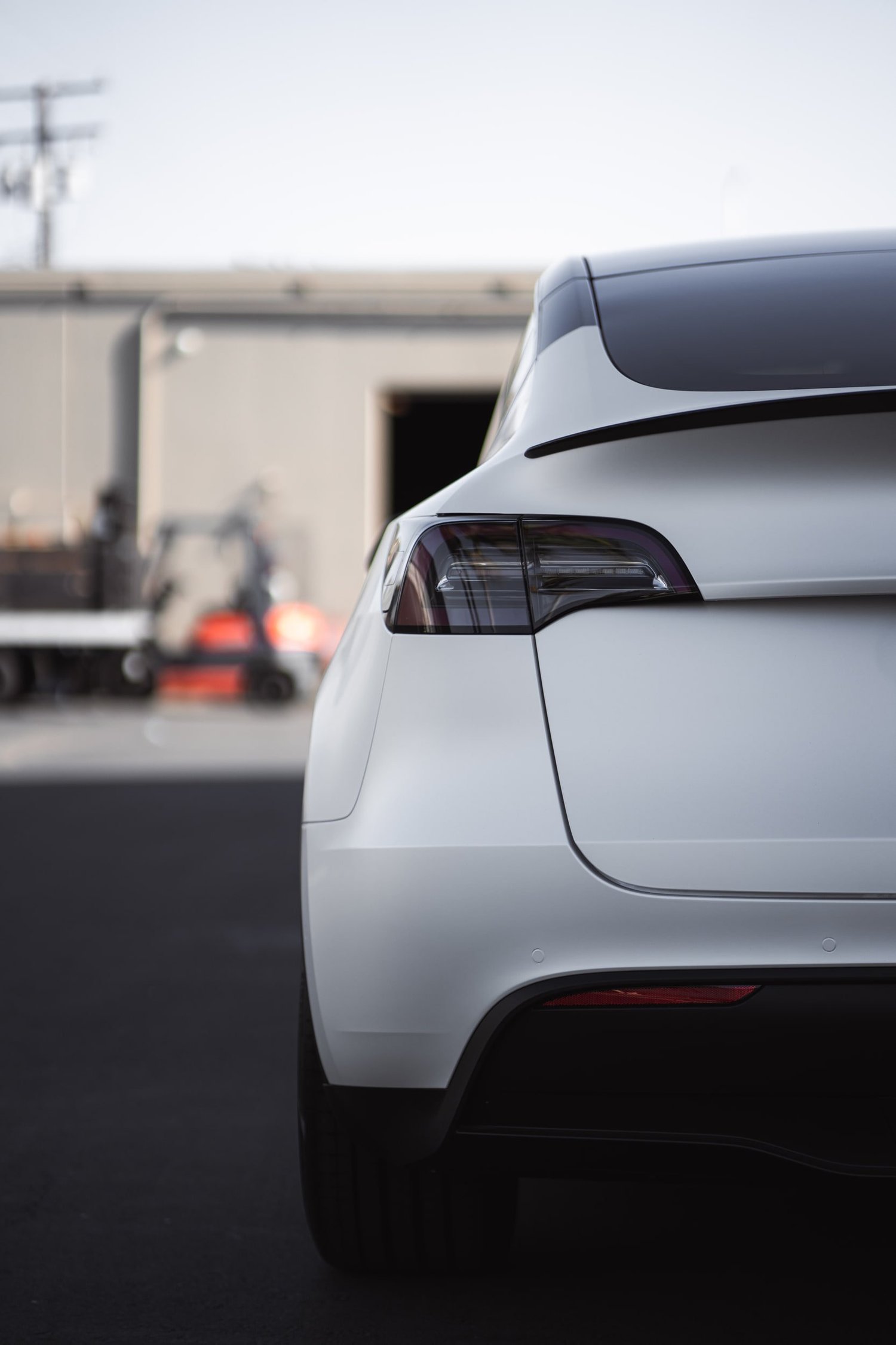 Satin Pearl White Tesla Model Y after Vinyl Wrap, rear bumper and taillight detail