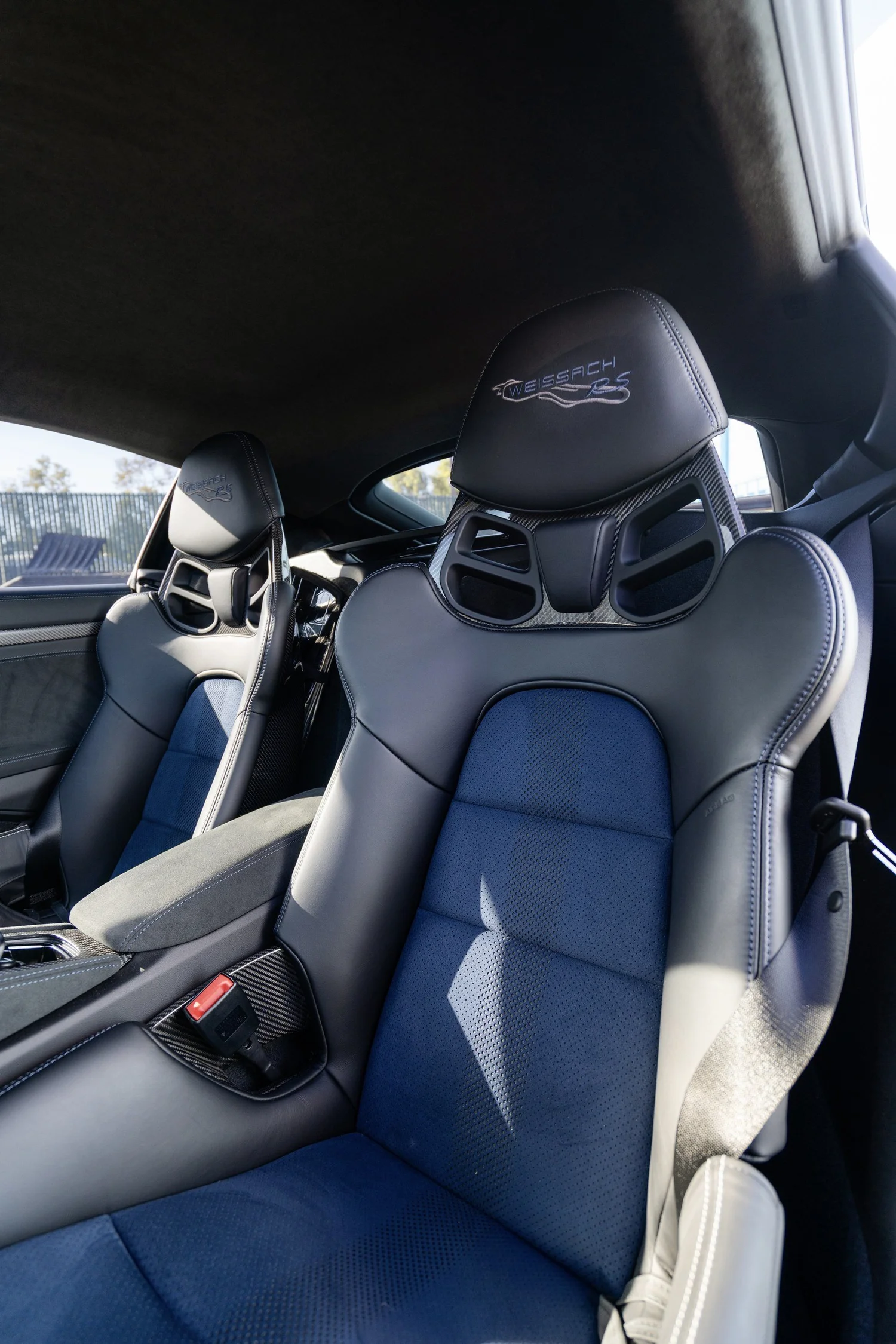 GT4 RS bucket seats with blue center inserts and blue stitching inside the cabin.
