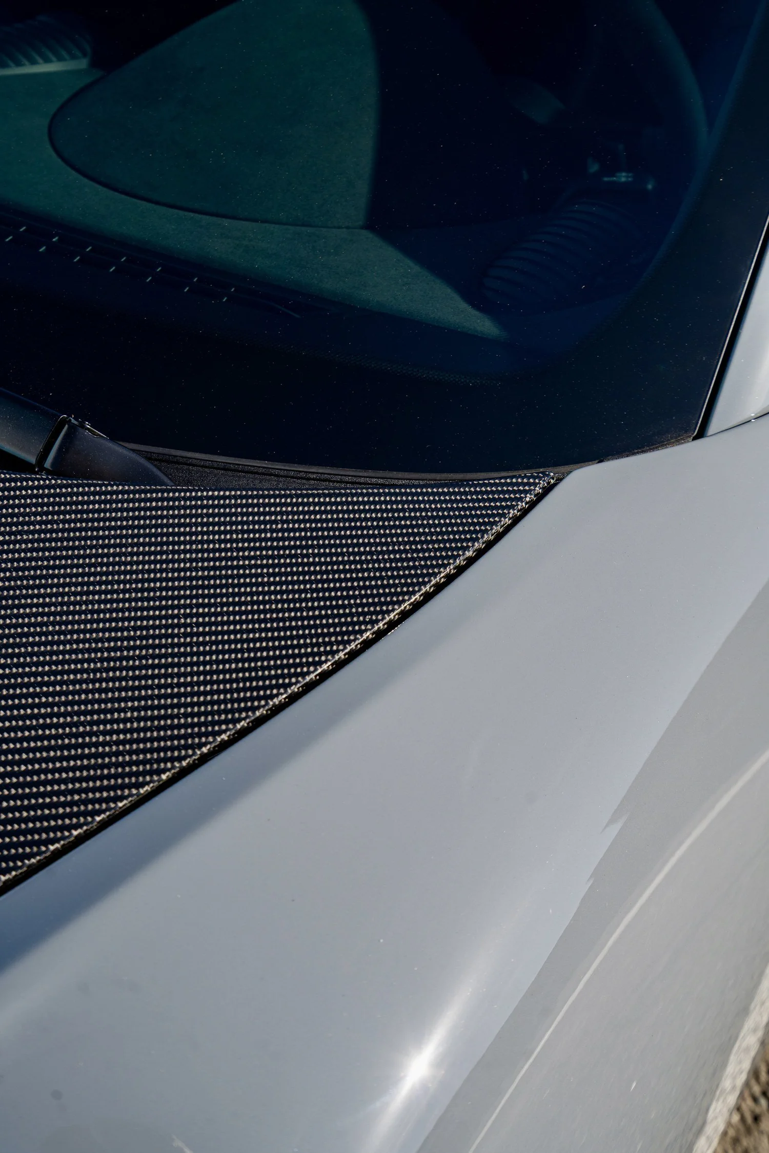GT4 RS front windshield base and wiper above the exposed carbon hood and Arctic Grey fender.