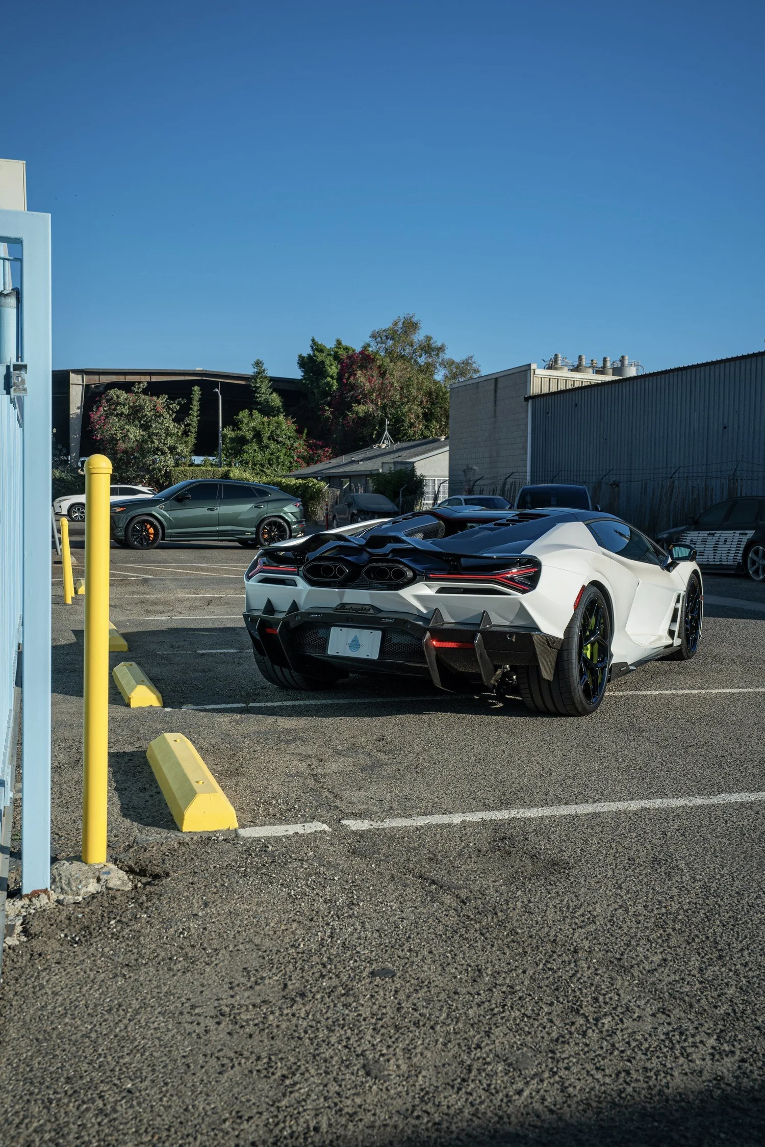 Rear three-quarter view of the white Revuelto with its carbon rear aero visible.