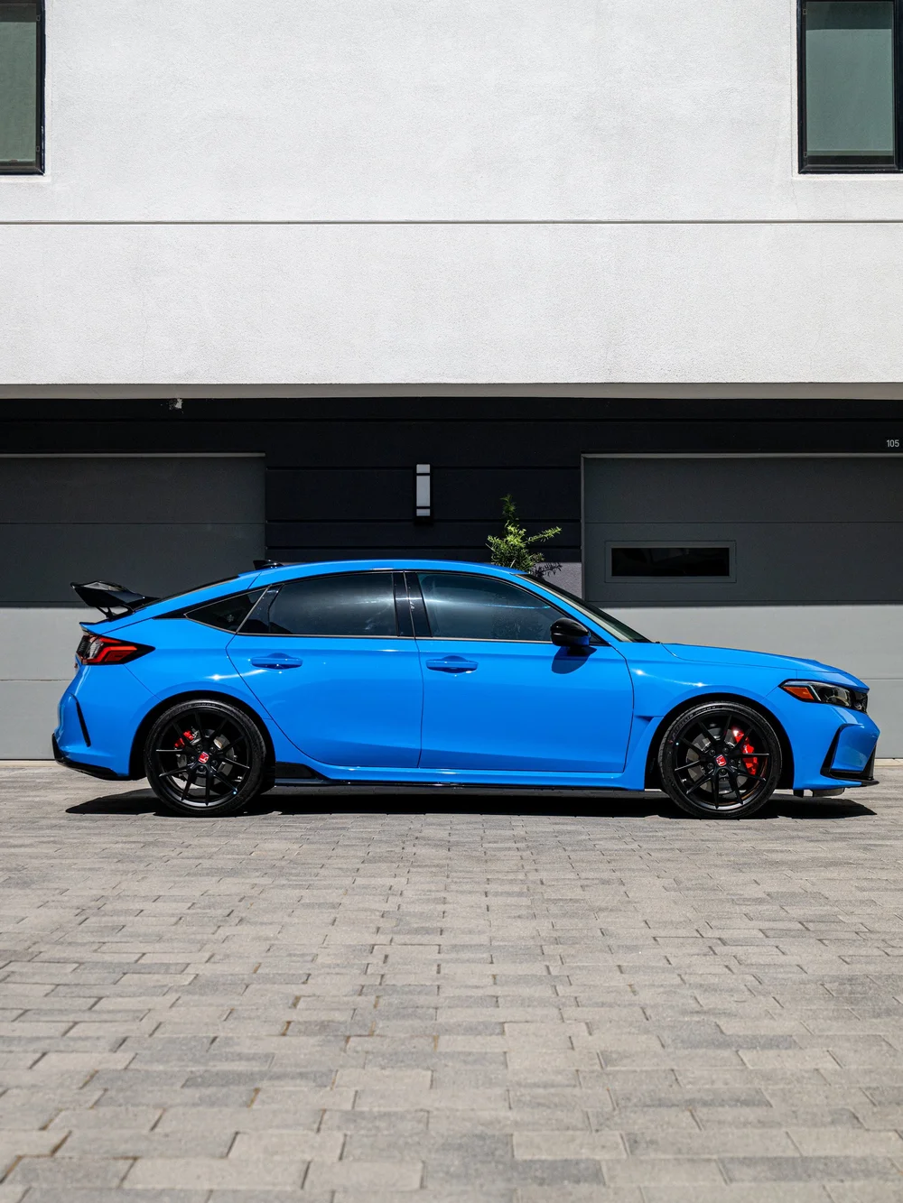 Full side profile of a Boost Blue Pearl 2026 Honda Civic Type R FL5