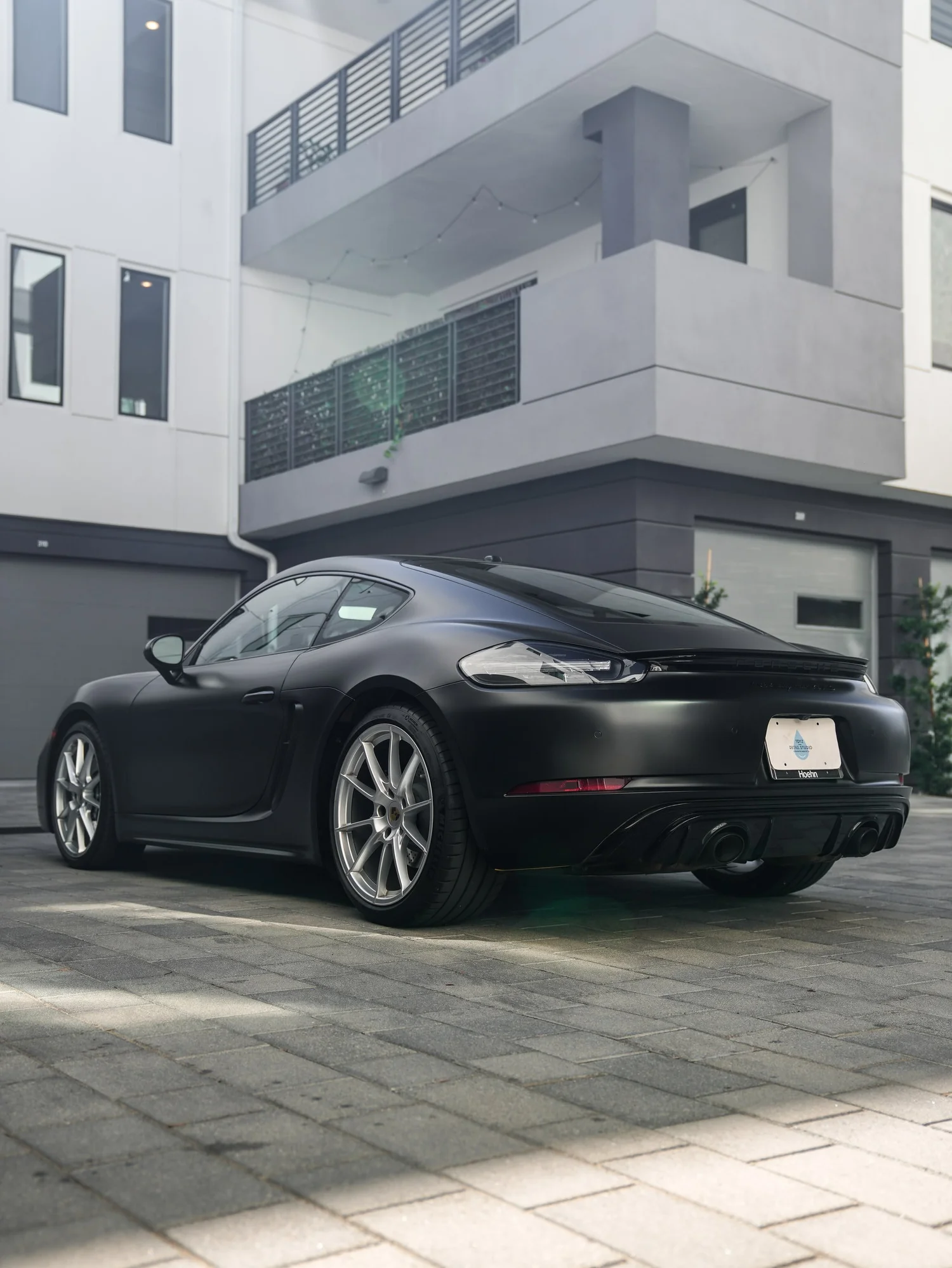 Porsche 718 Cayman GTS 3M Satin Black after Vinyl Wrap, rear-right three-quarter view