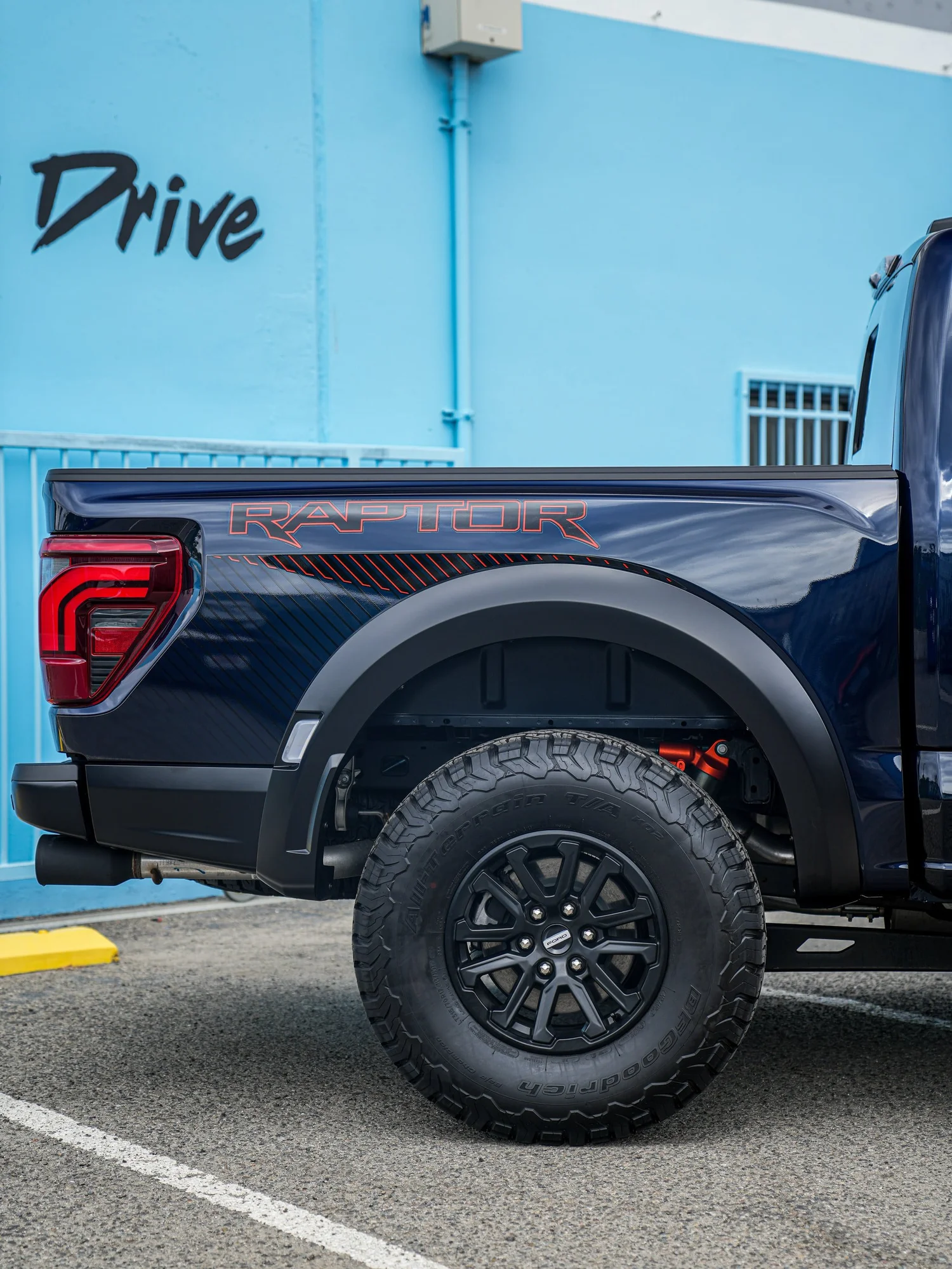 Dark Blue Ford F-150 Raptor after Paint Protection Film (PPF) and Window Tint, rear-quarter and wheel view