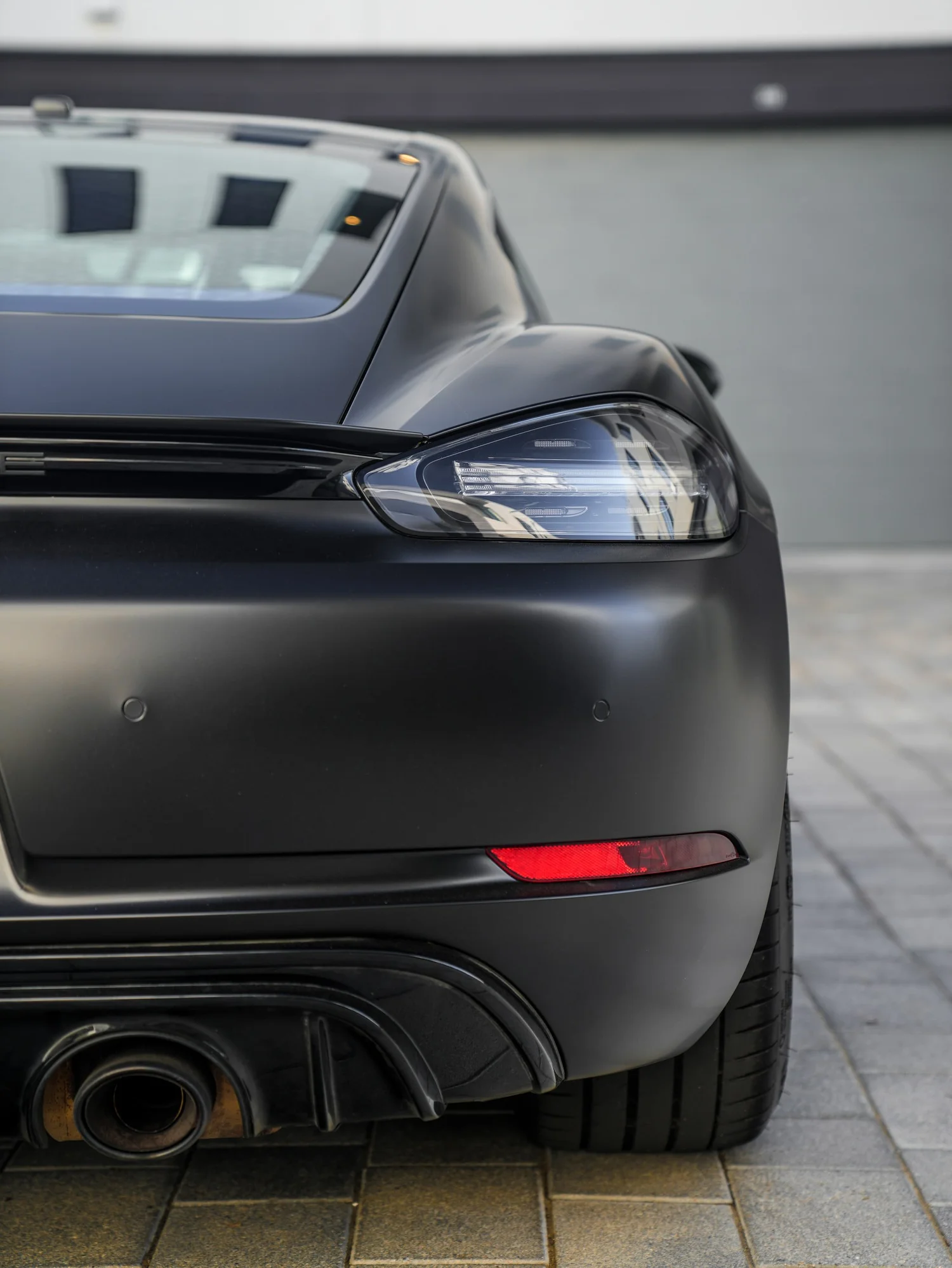 Porsche 718 Cayman GTS 3M Satin Black after Vinyl Wrap, rear body and taillight view