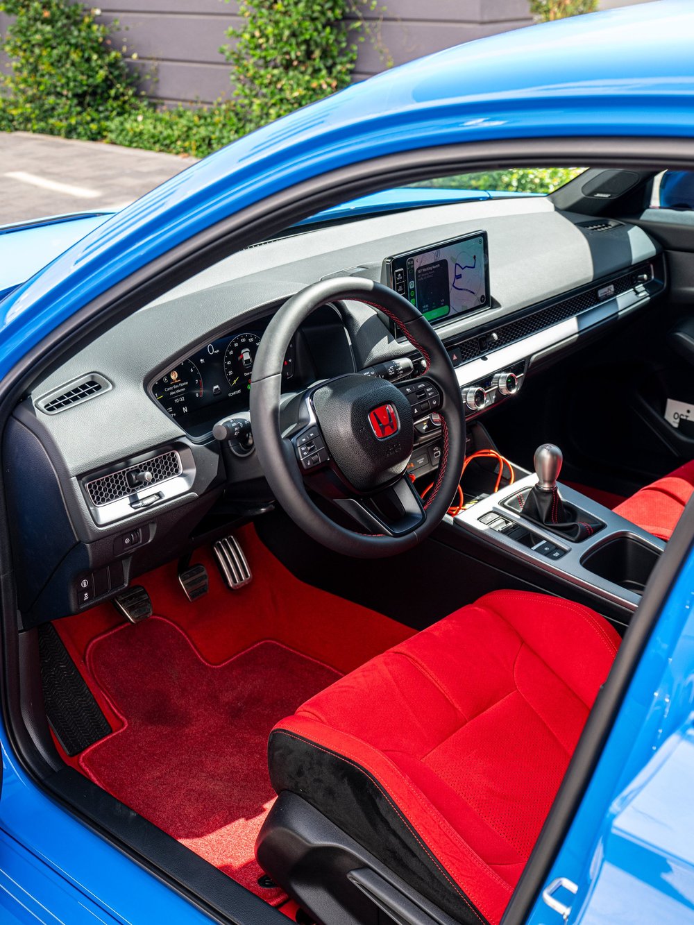 Driver cockpit of a 2026 Honda Civic Type R FL5 with red interior accents