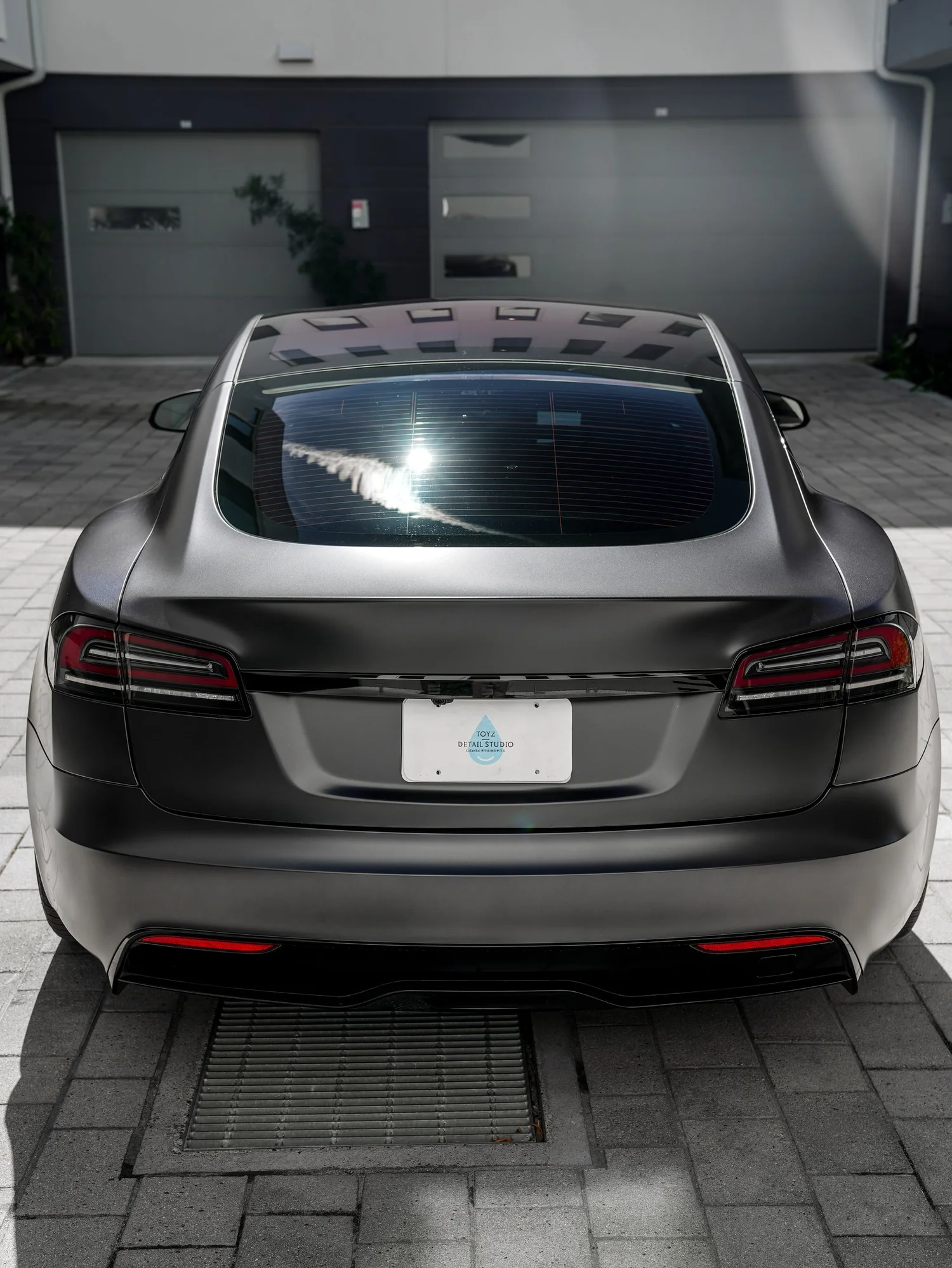 Tesla Model S after Matte PPF and Window Tint, low-angle rear view