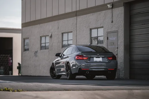Nardo Grey BMW 440i in a wide rear three-quarter view