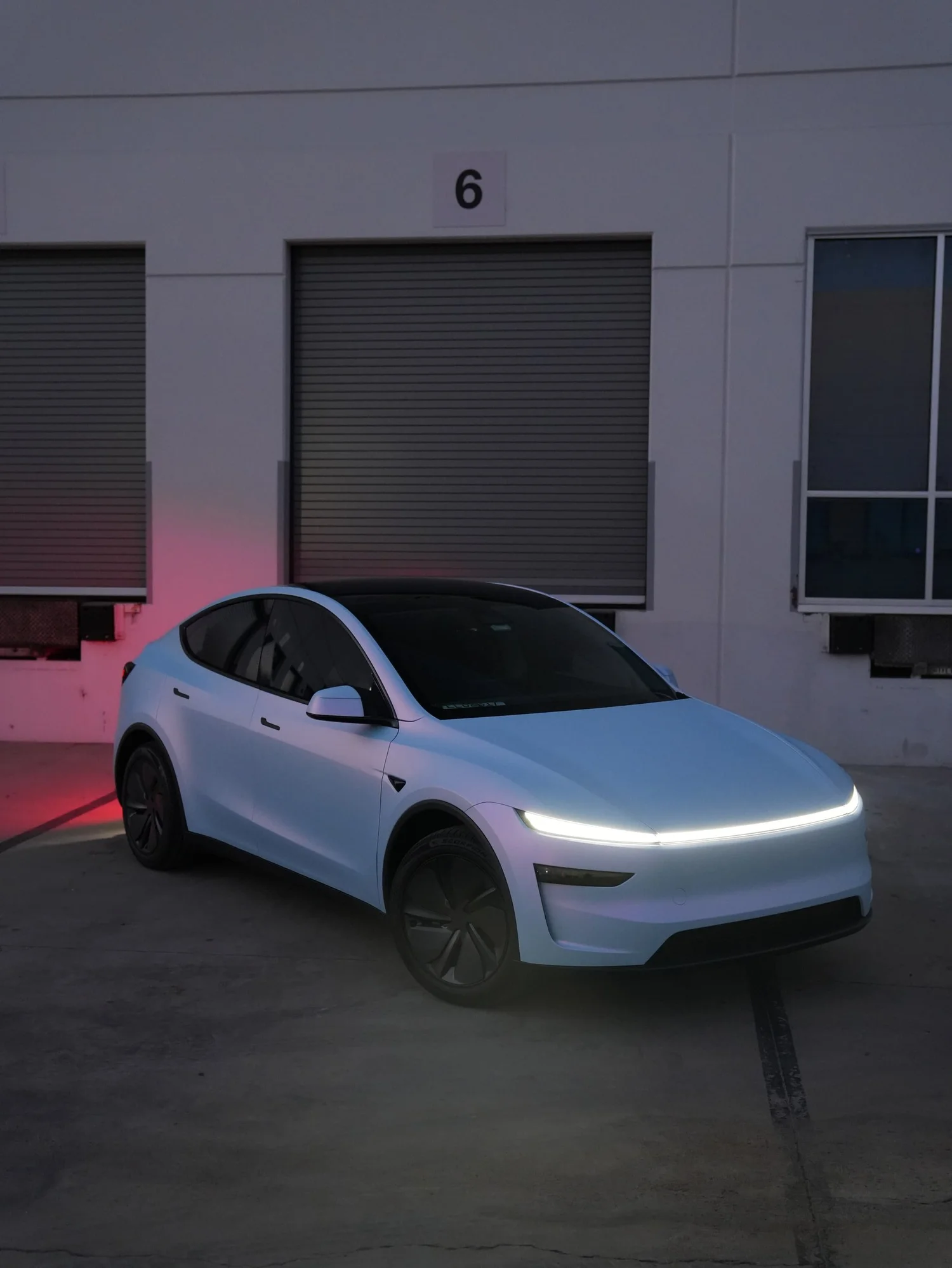 Tesla Model Y Color-Shifting White-to-Blue after Vinyl Wrap, low-angle front view