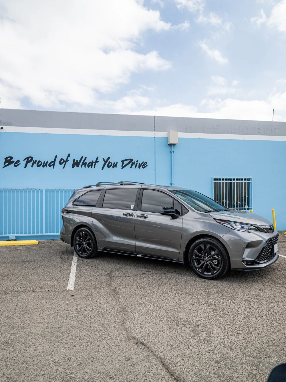 Side view of a Heavy Metal Toyota Sienna XSE showing dark XPEL XR Plus window tint