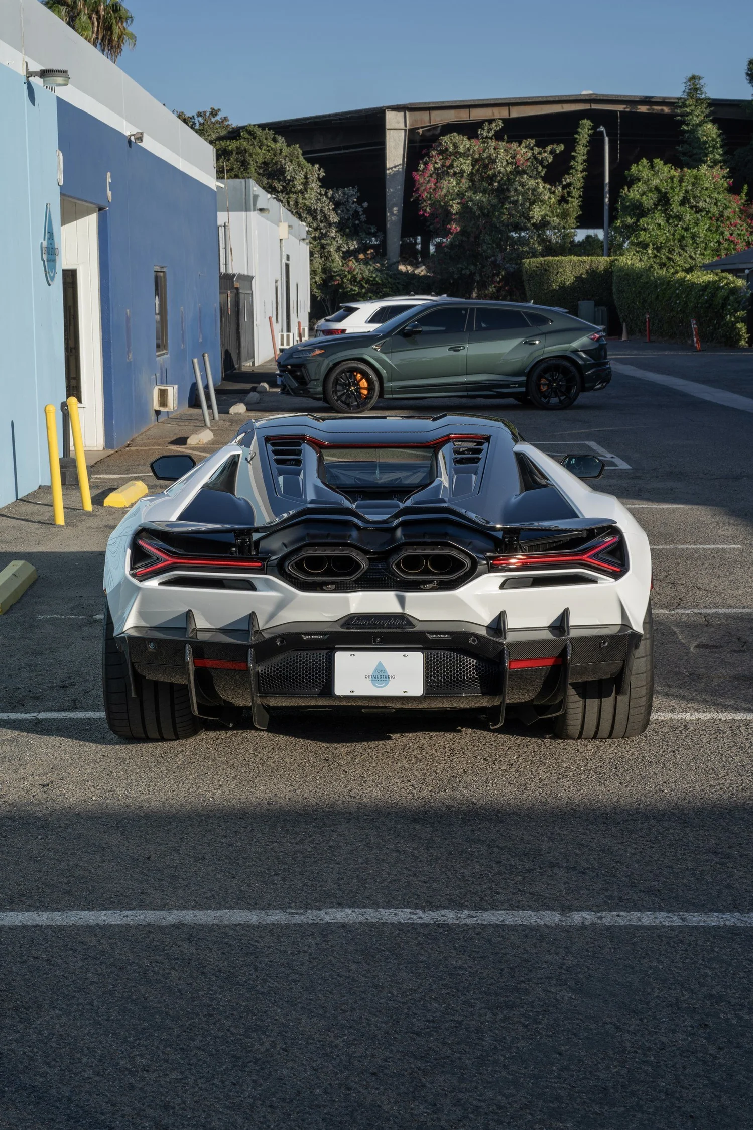 Full rear view of the white Revuelto with the engine cover open.