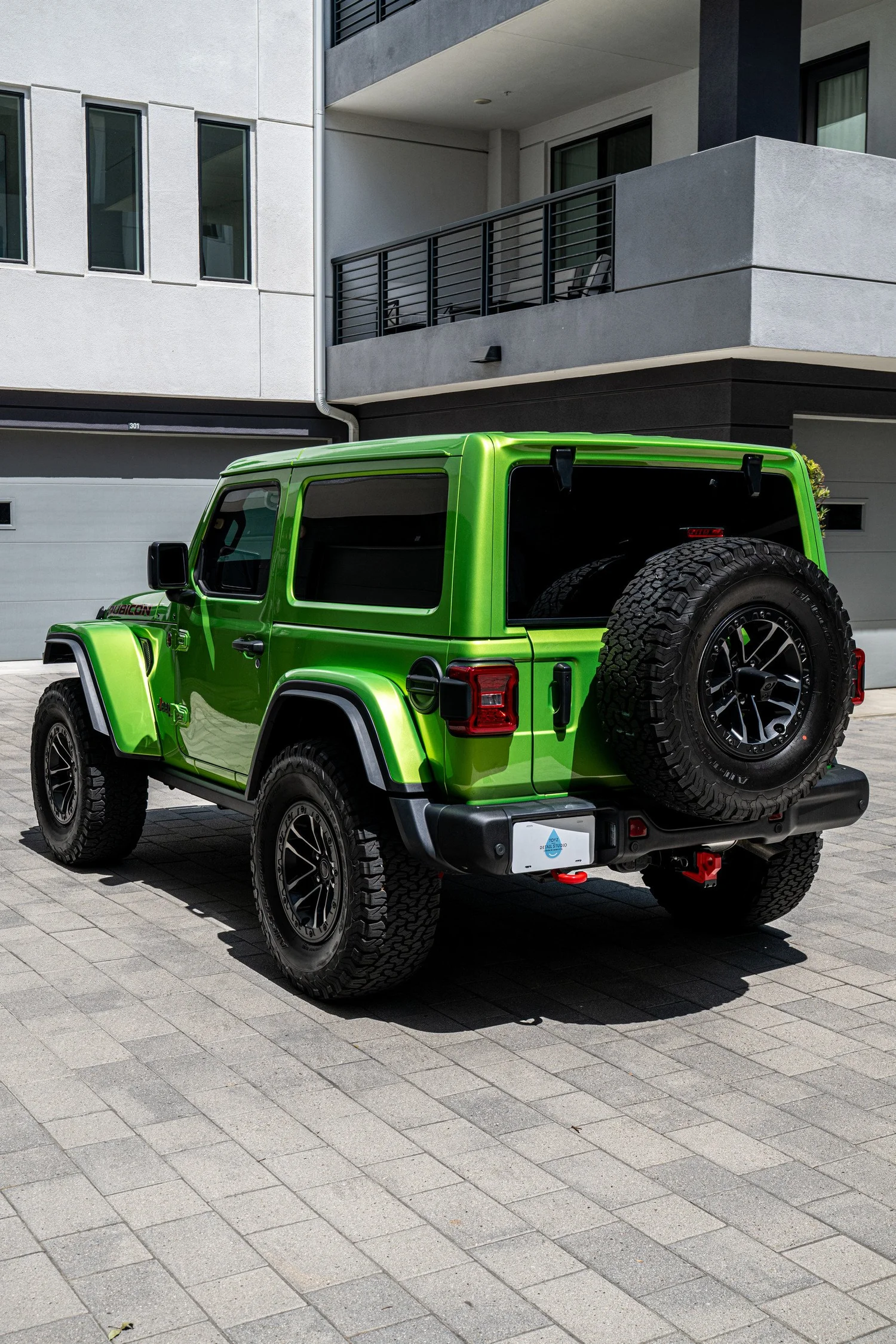 Rear three-quarter view of the 2026 Mojito Wrangler Rubicon showing its painted roof, side bodywork and spare tire