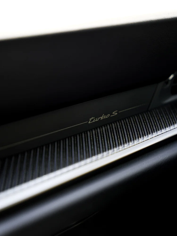 Turbo S inscription above the carbon-fiber-patterned door sill.