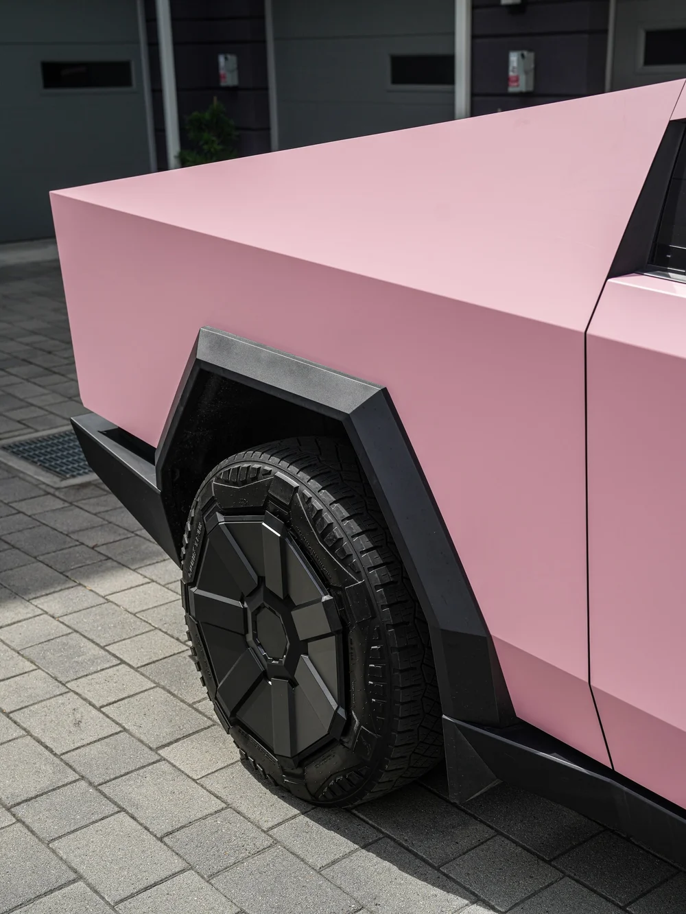 Tesla Cybertruck with Satin Fresh Pink vinyl wrap, rear wheel and bed side body-panel detail