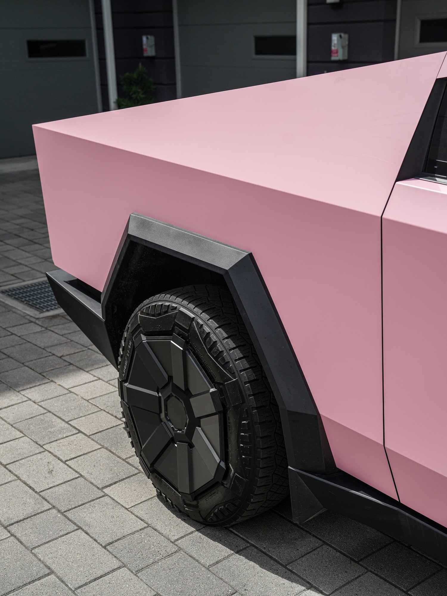 Satin Fresh Pink Tesla Cybertruck after Vinyl Wrap, rear-quarter and wheel view