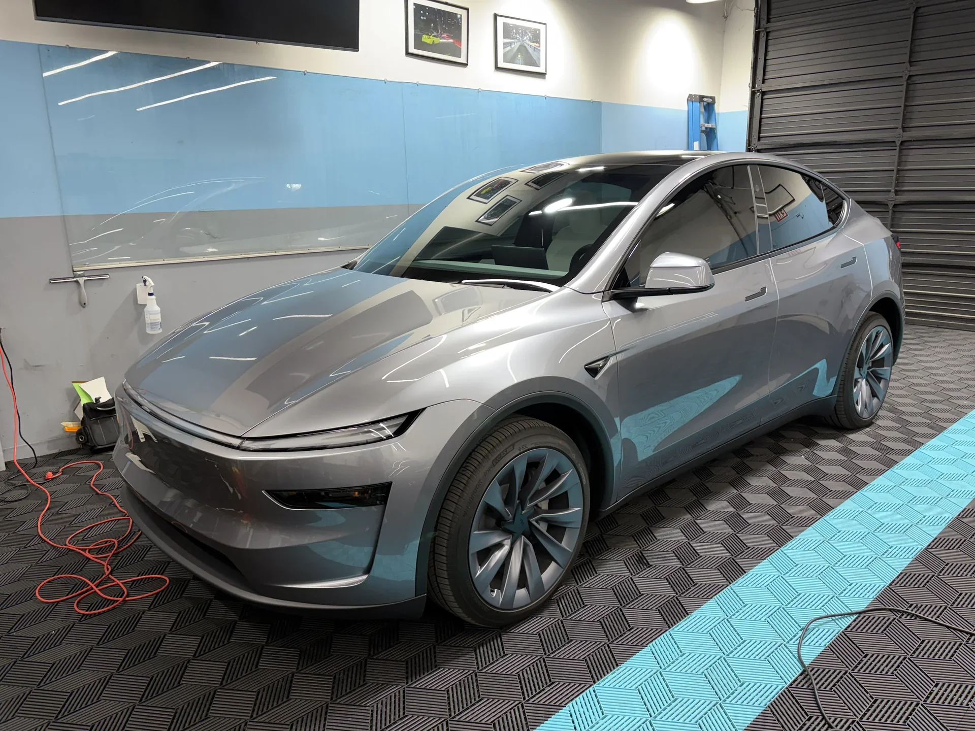 2026 Tesla Model Y — front three-quarter view inside the studio
