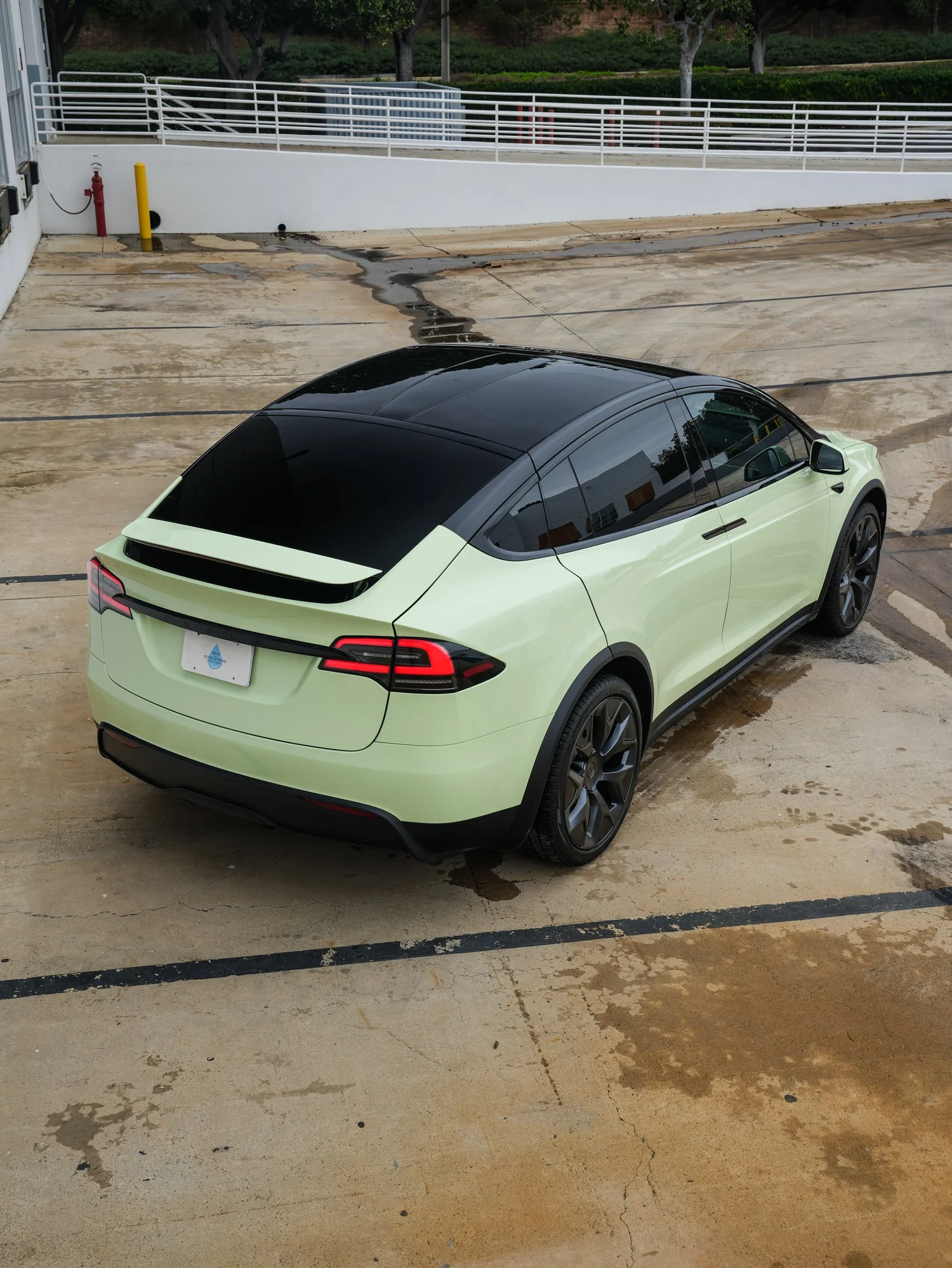 Tesla Model X Avocado Green after Vinyl Wrap, rear-left three-quarter view