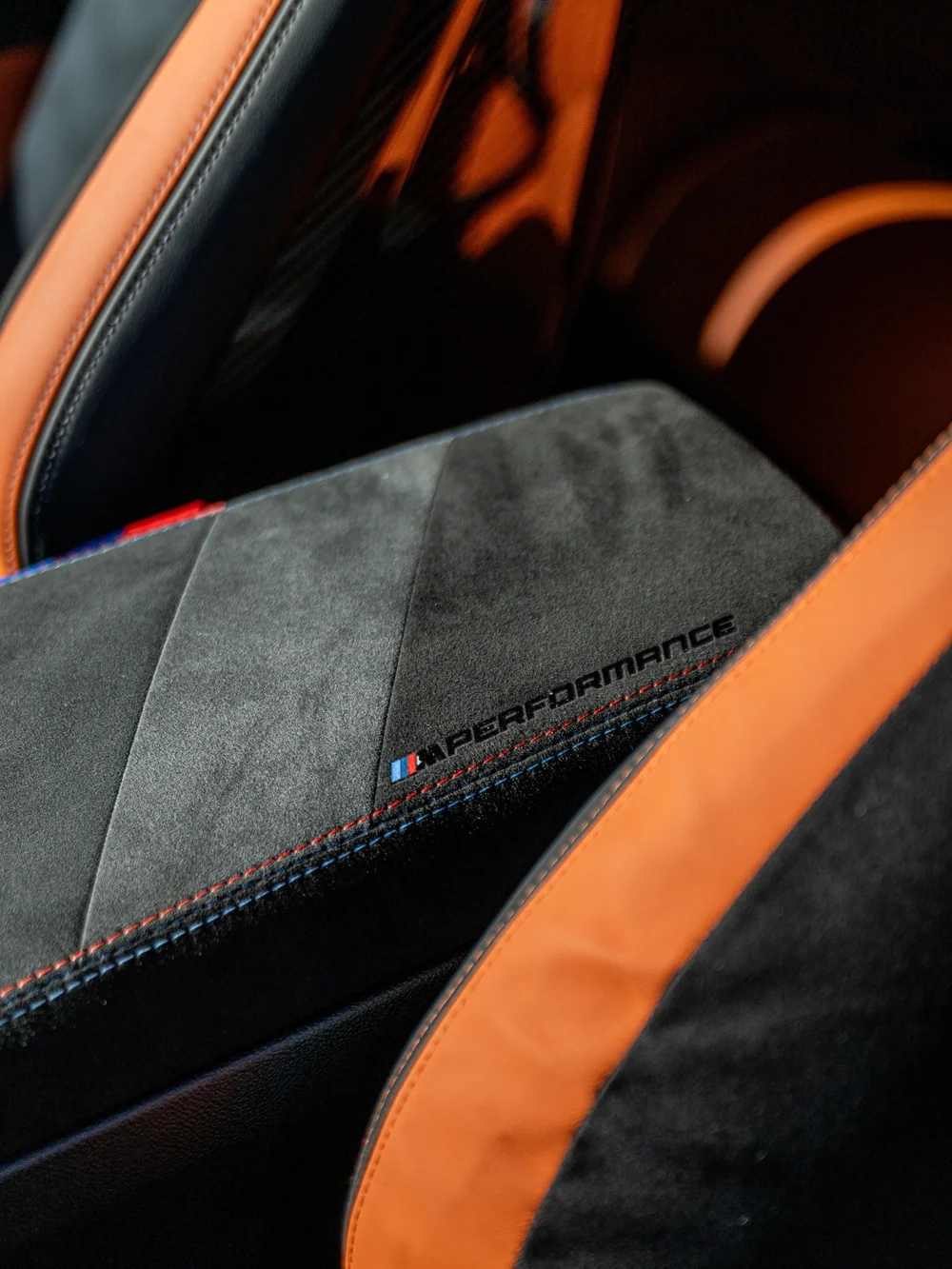 M Performance embroidered armrest and orange interior trim in the manual BMW M3