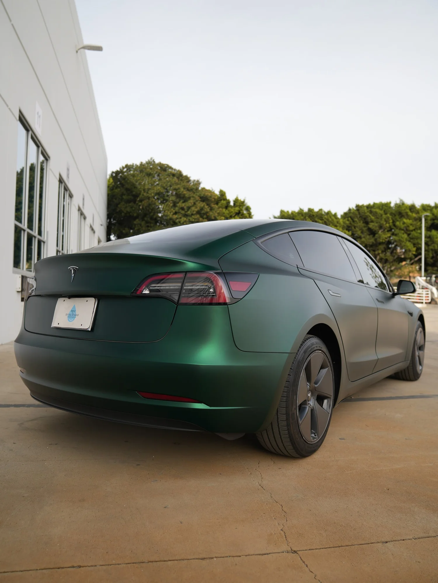 Tesla Model 3 Ghost Matte Green after Vinyl Wrap, rear-right three-quarter view