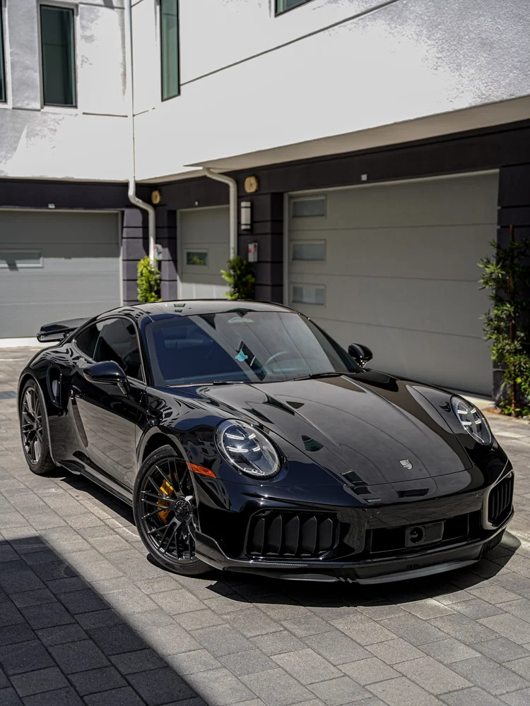 Alternate front three-quarter view of the Turbo S beside the studio garage doors.