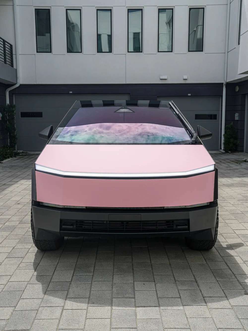 Tesla Cybertruck with Satin Fresh Pink vinyl wrap, direct front full vehicle