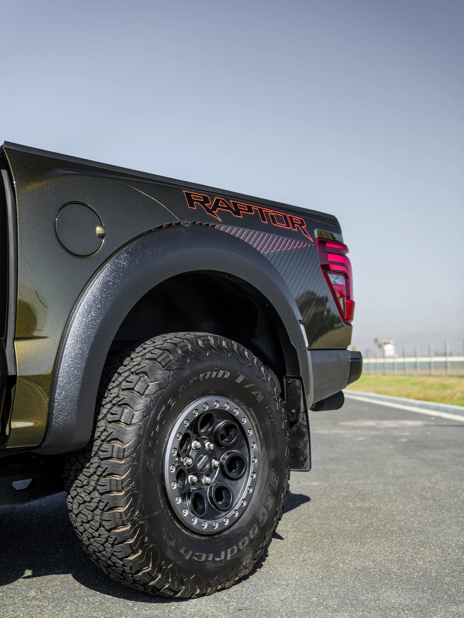 Black Ford F-150 Raptor after Paint Protection Film (PPF) and Window Tint, rear-quarter and wheel view