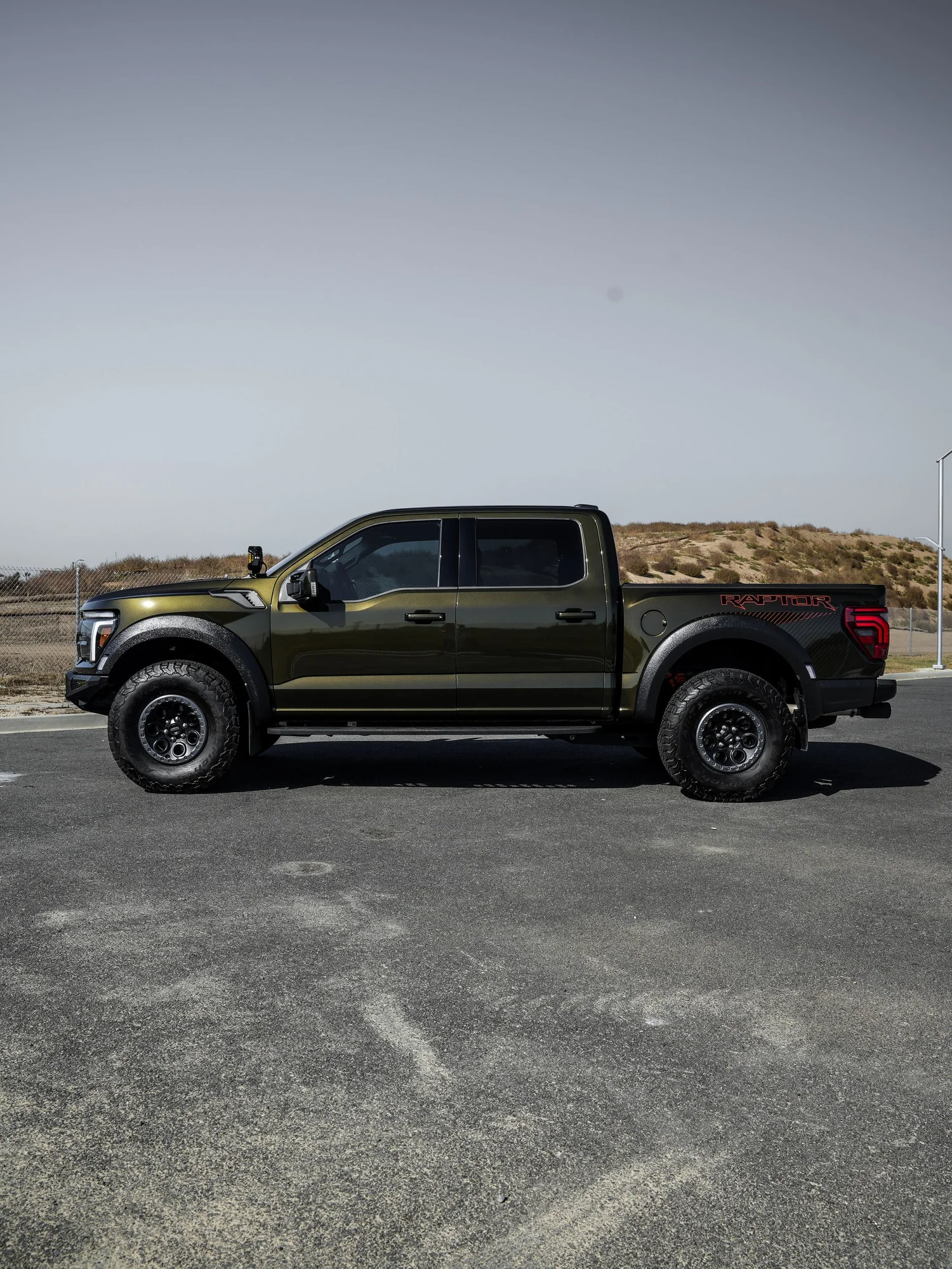Black Ford F-150 Raptor after Paint Protection Film (PPF) and Window Tint, left-side profile