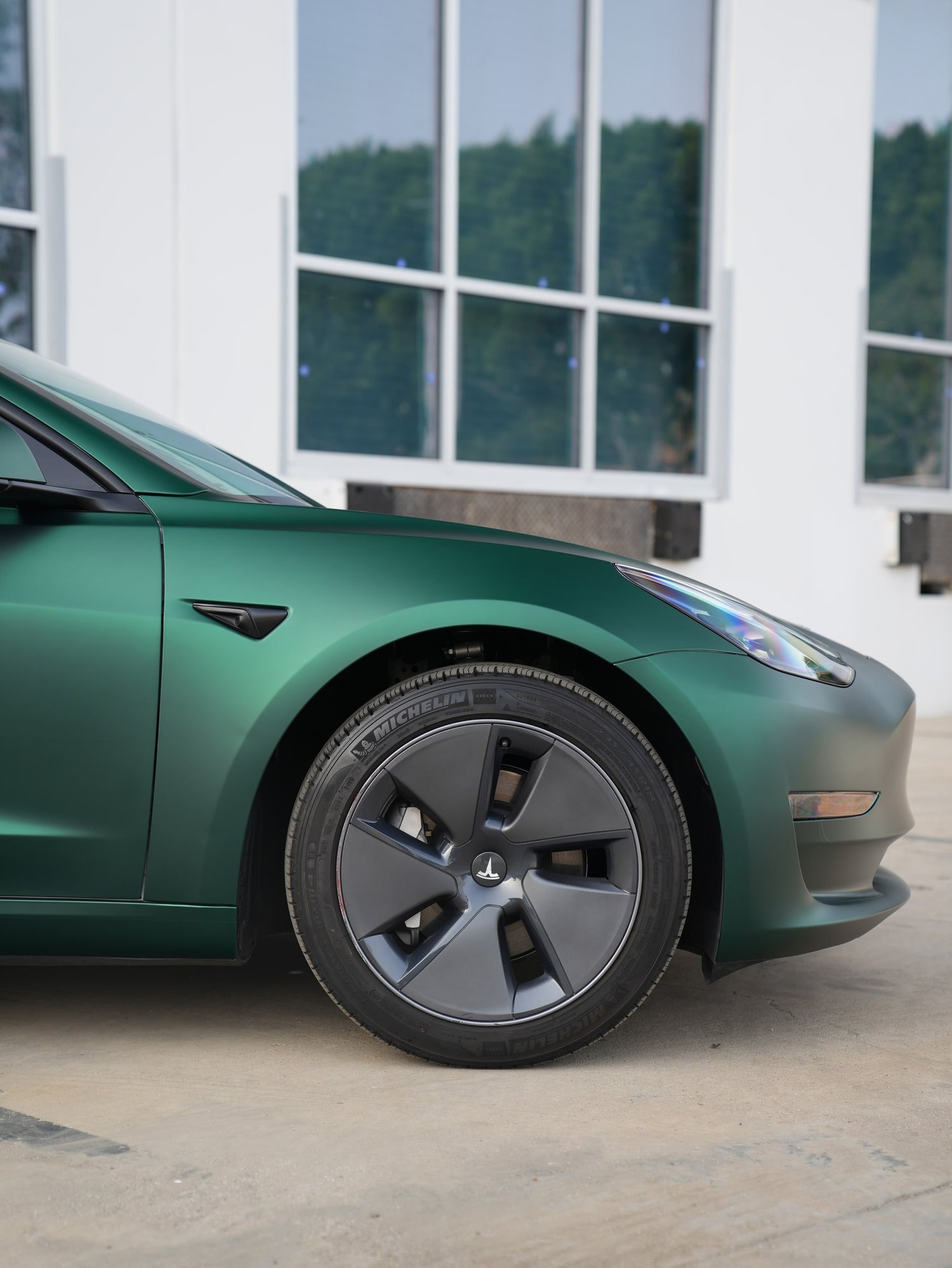 Tesla Model 3 Ghost Matte Green after Vinyl Wrap, front wheel and body view