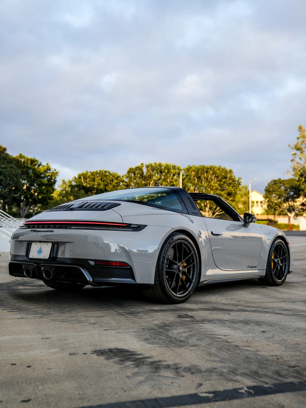 Complete Porsche Targa in a low rear three-quarter view beneath a cloudy sky