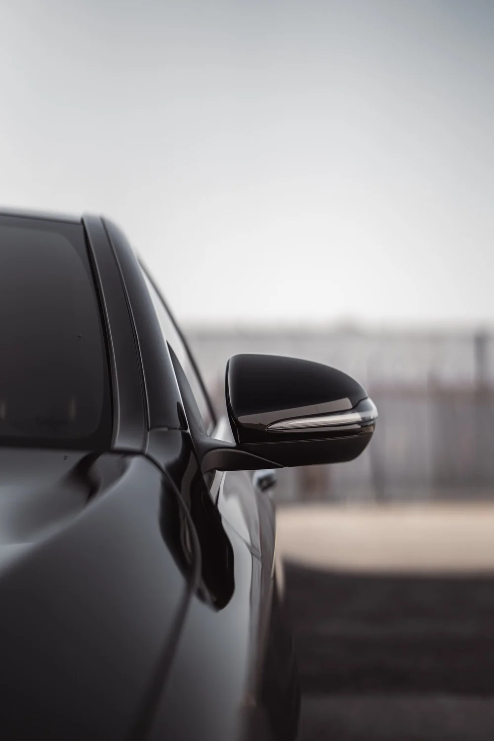 Mercedes-Benz C 300 side mirror and side-window edge in a portrait detail photograph