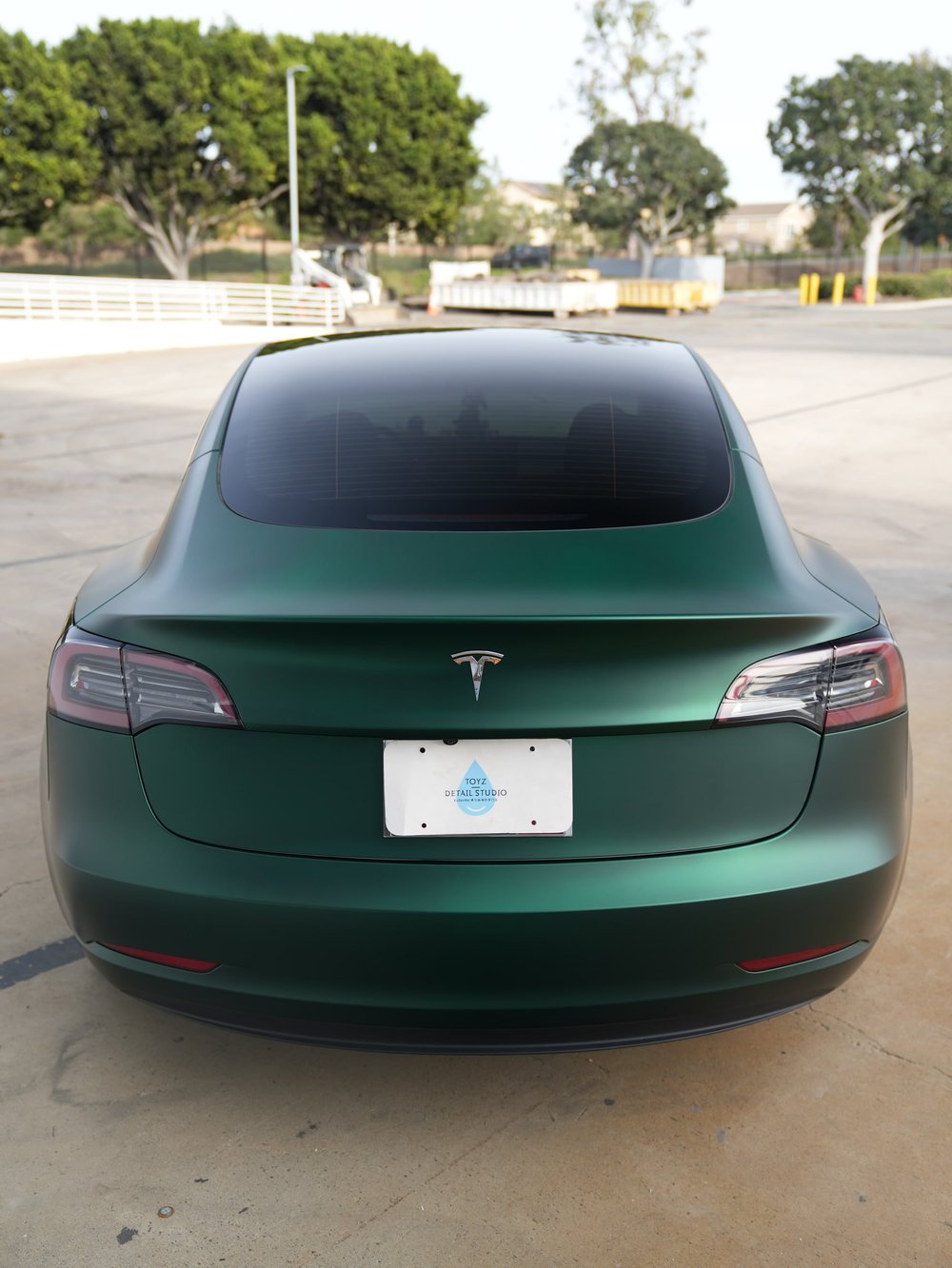 Direct rear view of the Tesla Model 3 with Ghost Matte Green vinyl wrap
