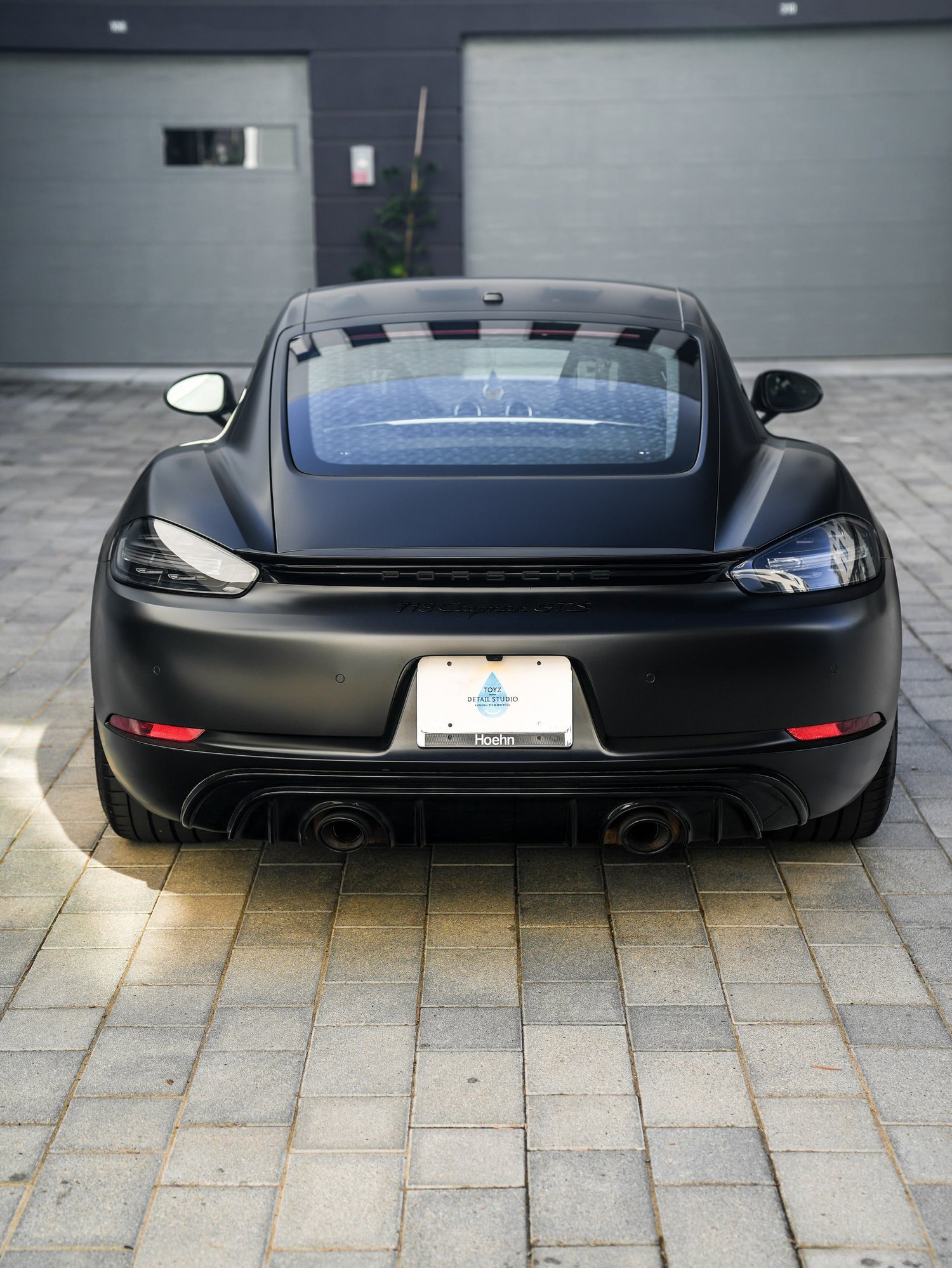 Porsche 718 Cayman GTS 3M Satin Black after Vinyl Wrap, low-angle rear view