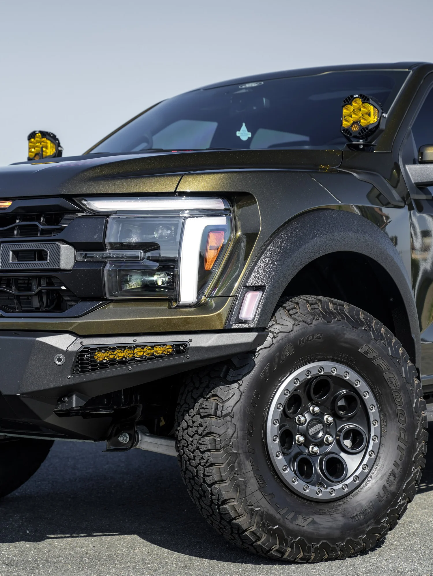 Black Ford F-150 Raptor after Paint Protection Film (PPF) and Window Tint, front wheel and body view