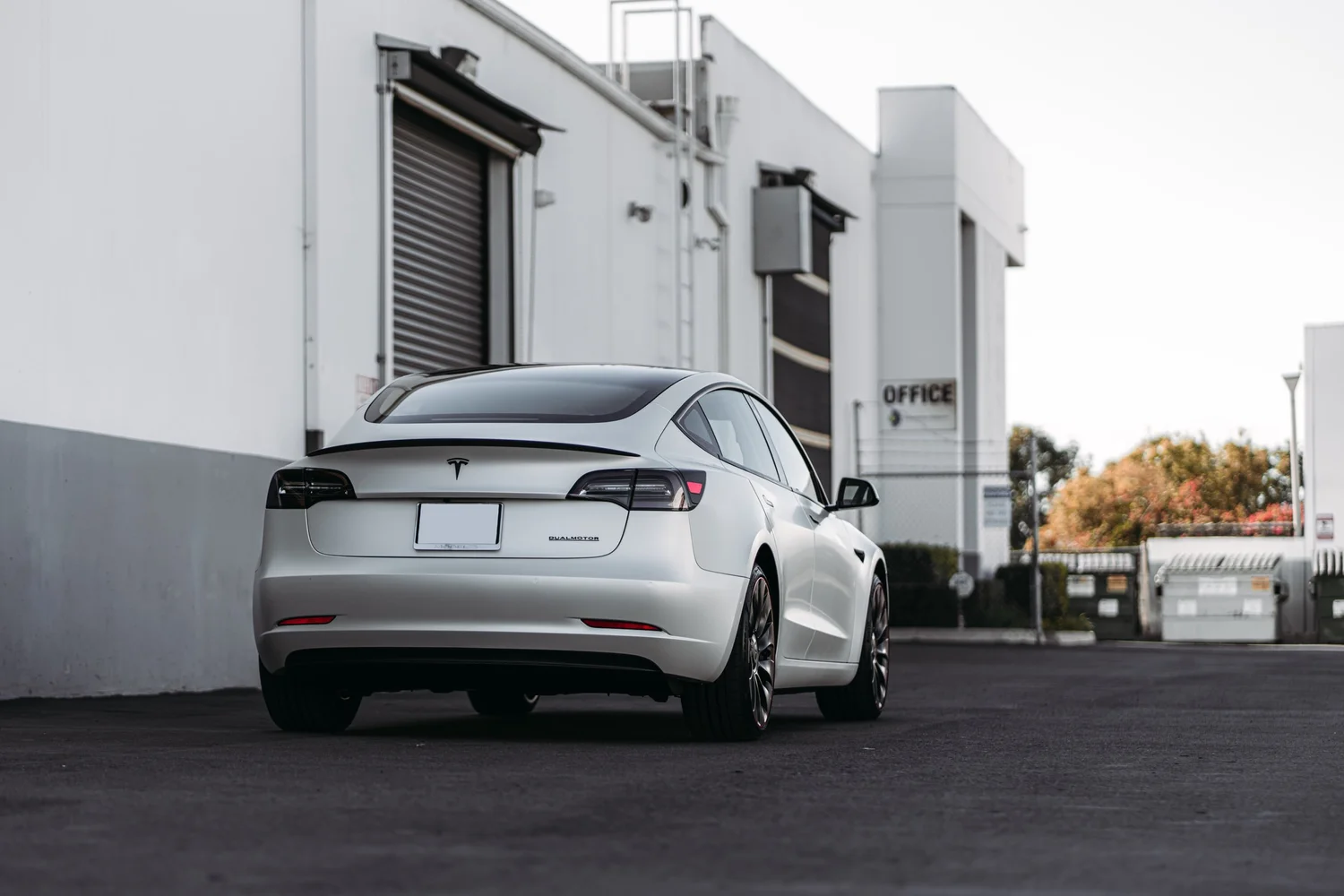 Tesla Model 3 3M 2080 Satin Pearl White after Vinyl Wrap, low-angle rear view
